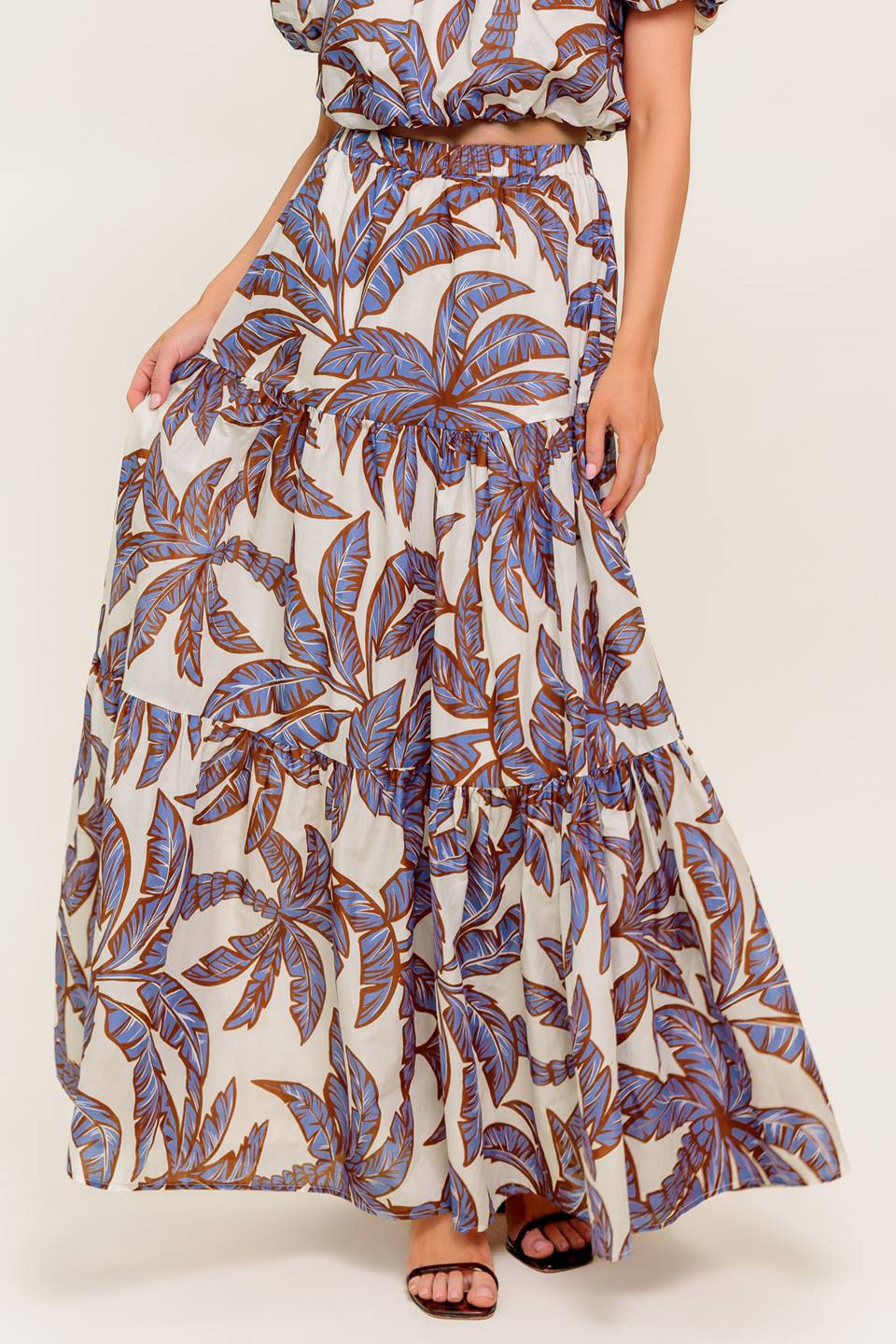 A printed woven maxi skirt featuring elasticized waist and tiers.