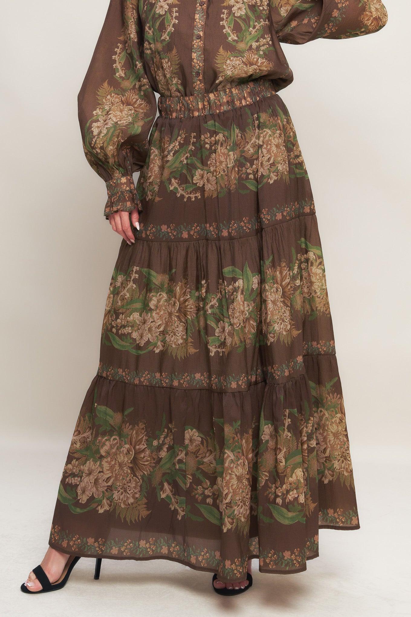 A printed woven maxi skirt featuring elasticized waist and tiers