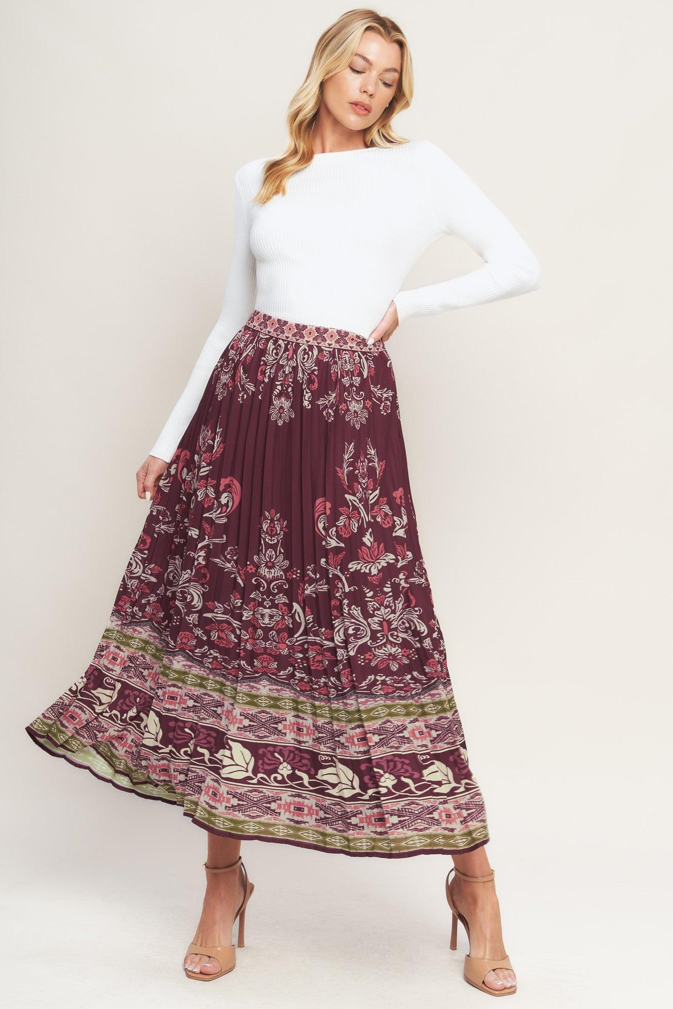 A printed woven pleated midi skirt with side zipper closure. Matching top IT13890
