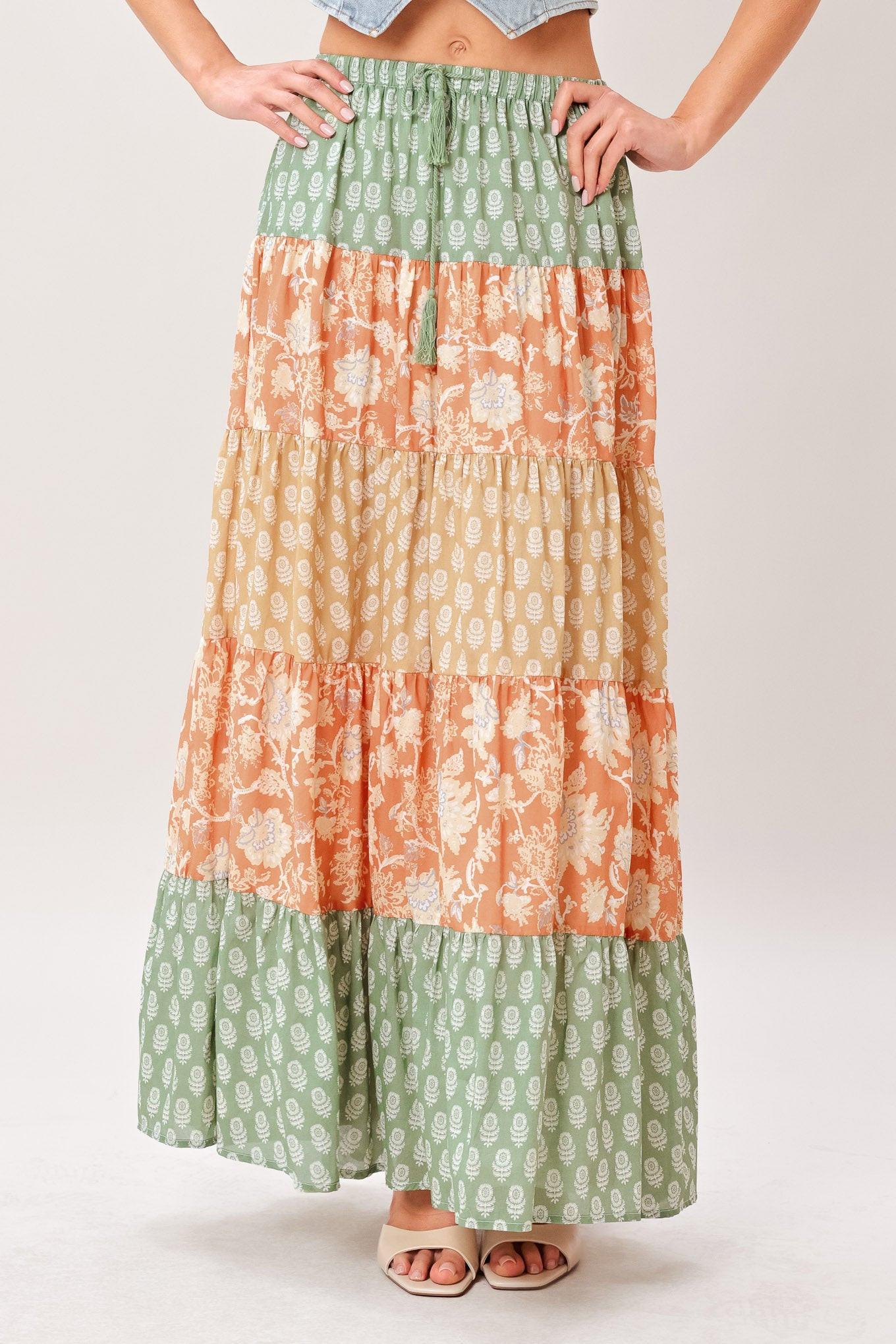 A mix print midi prairie skirt with elastic waist and tie/tassel