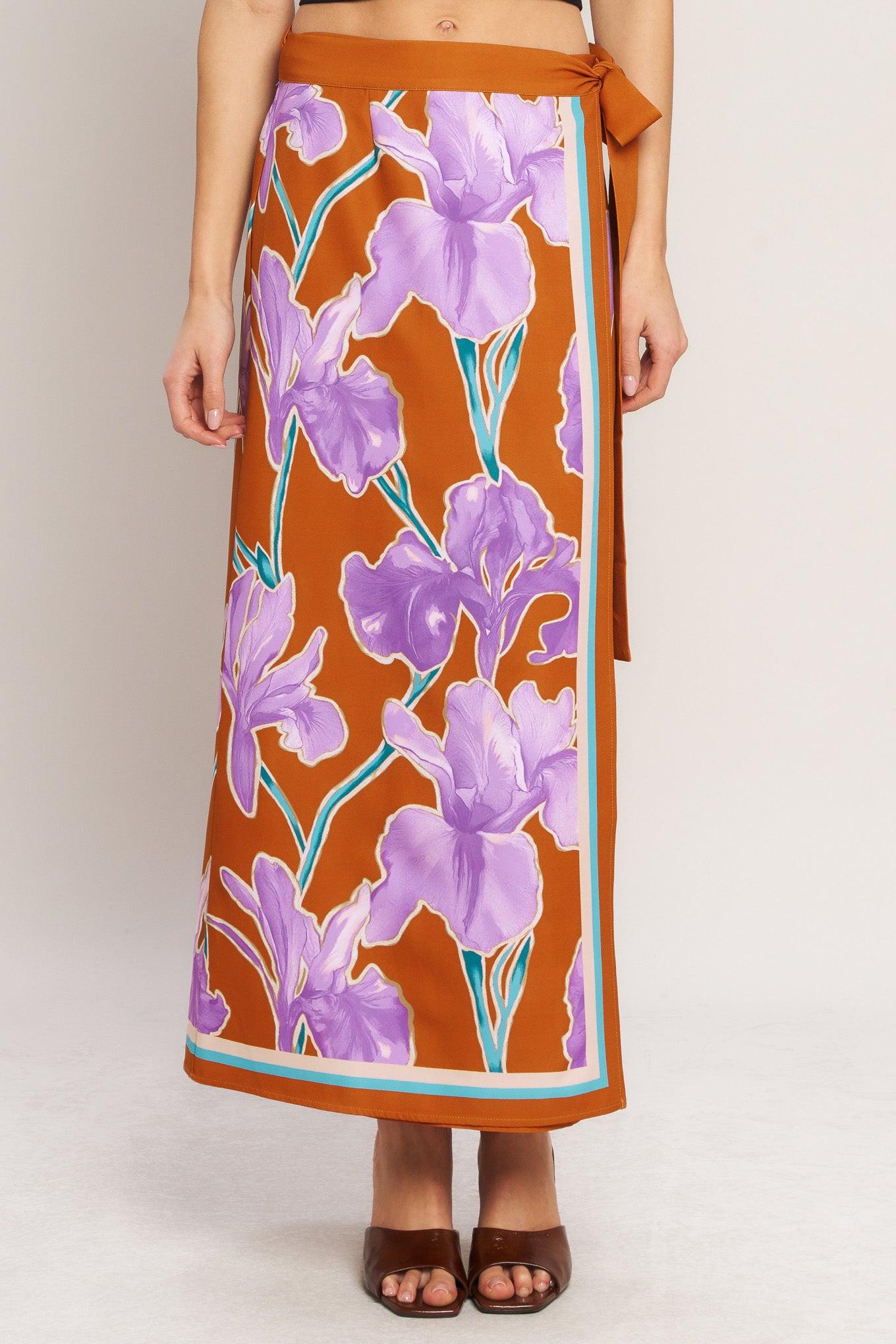 A printed woven midi wrap skirt with side tie.