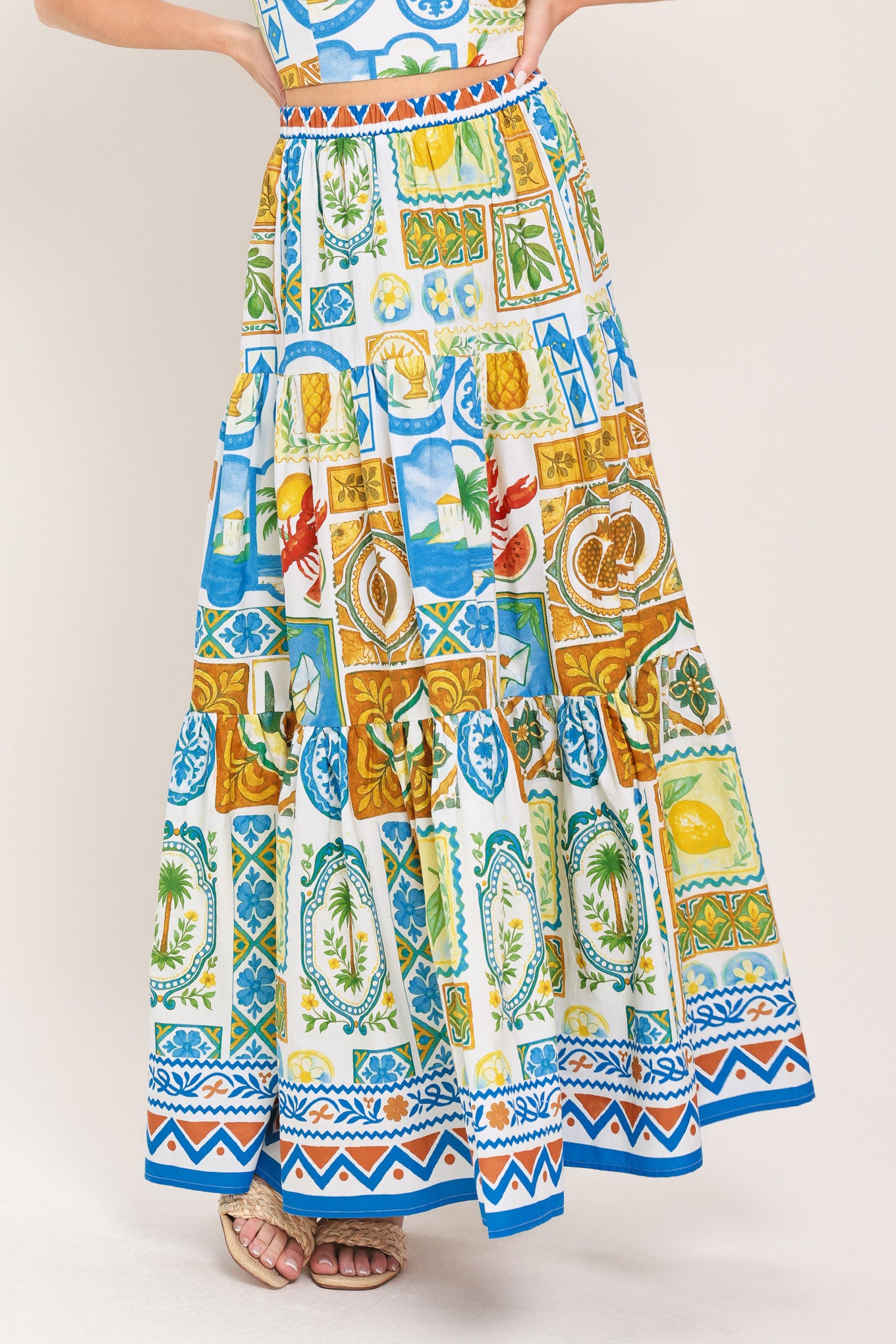 Woman wearing a maxi skirt with elastic waist and tiers featuring a bold, summer print | Flying Tomato