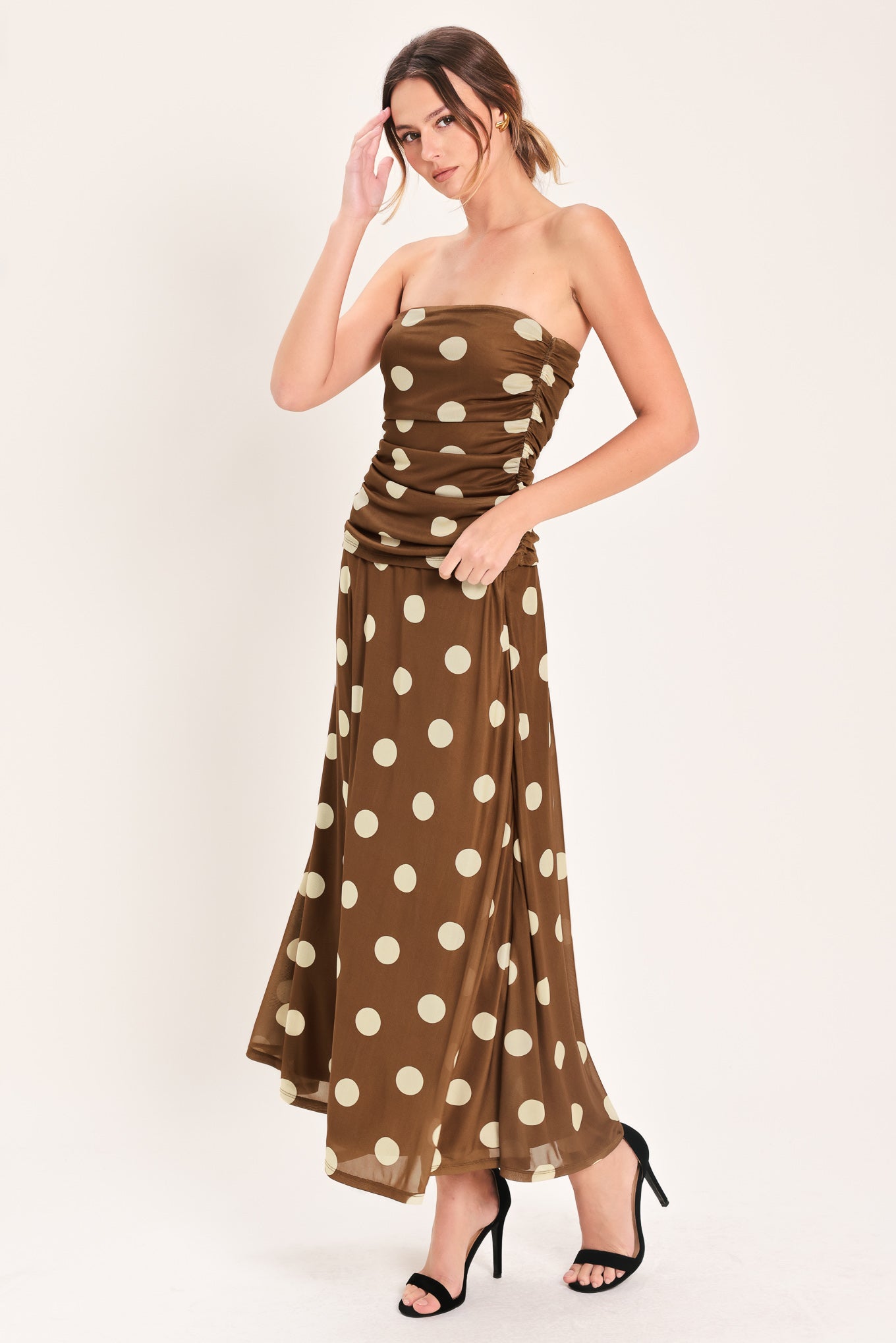 Woman wearing a brown polka dot midi skirt with elastic waist | Flying Tomato