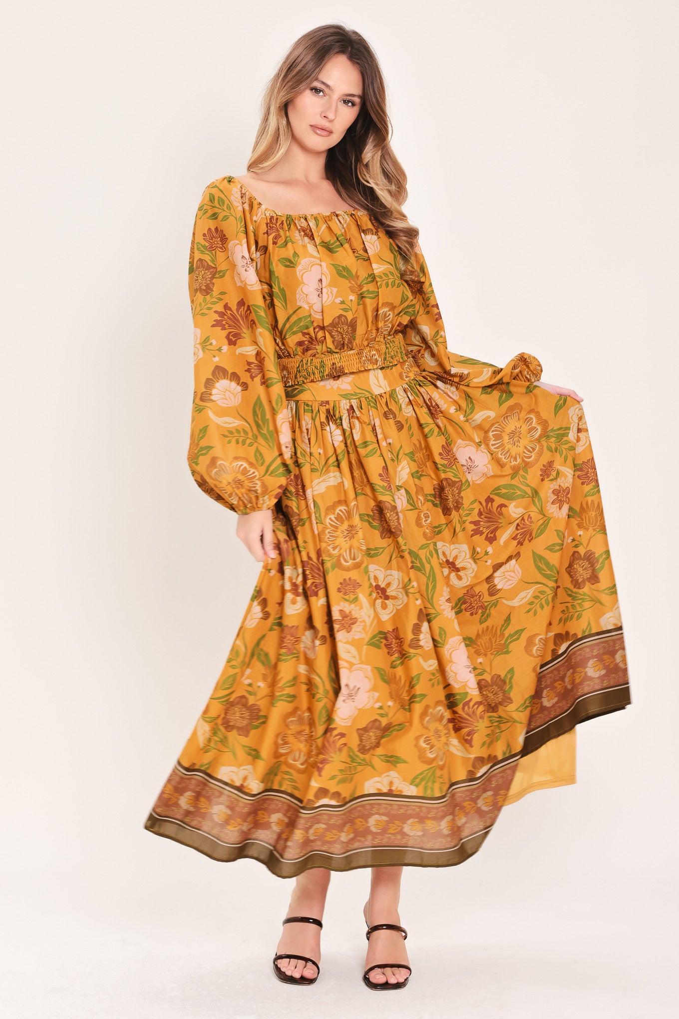 Woman wearing a mustard yellow floral patterned midi skirt | Flying Tomato