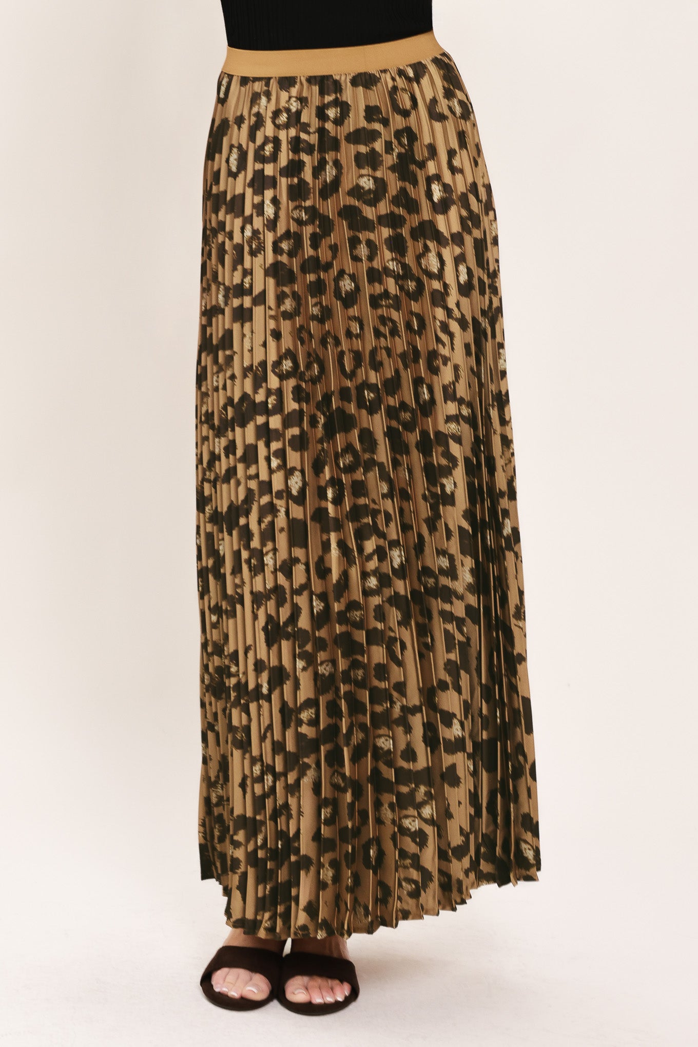 A pleated maxi skirt with a leopard print pattern in brown and black, featuring a solid tan waistband | Flying Tomato