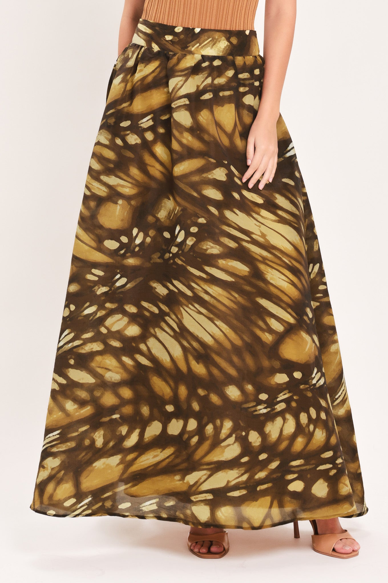 A woman wearing a dark brown maxi skirt with a butterfly-like pattern | Flying Tomato