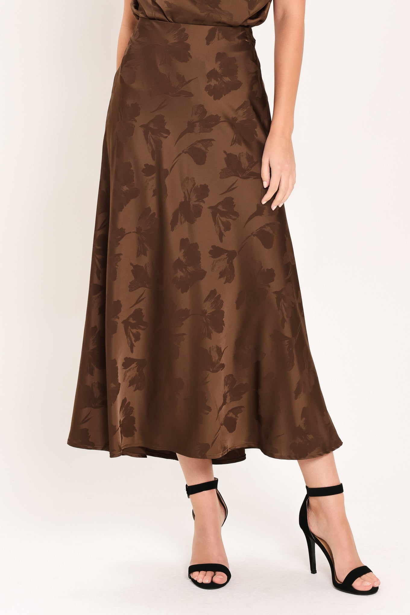 Woman wearing a brown woven jacquard midi skirt with back zipper closure | Flying Tomato