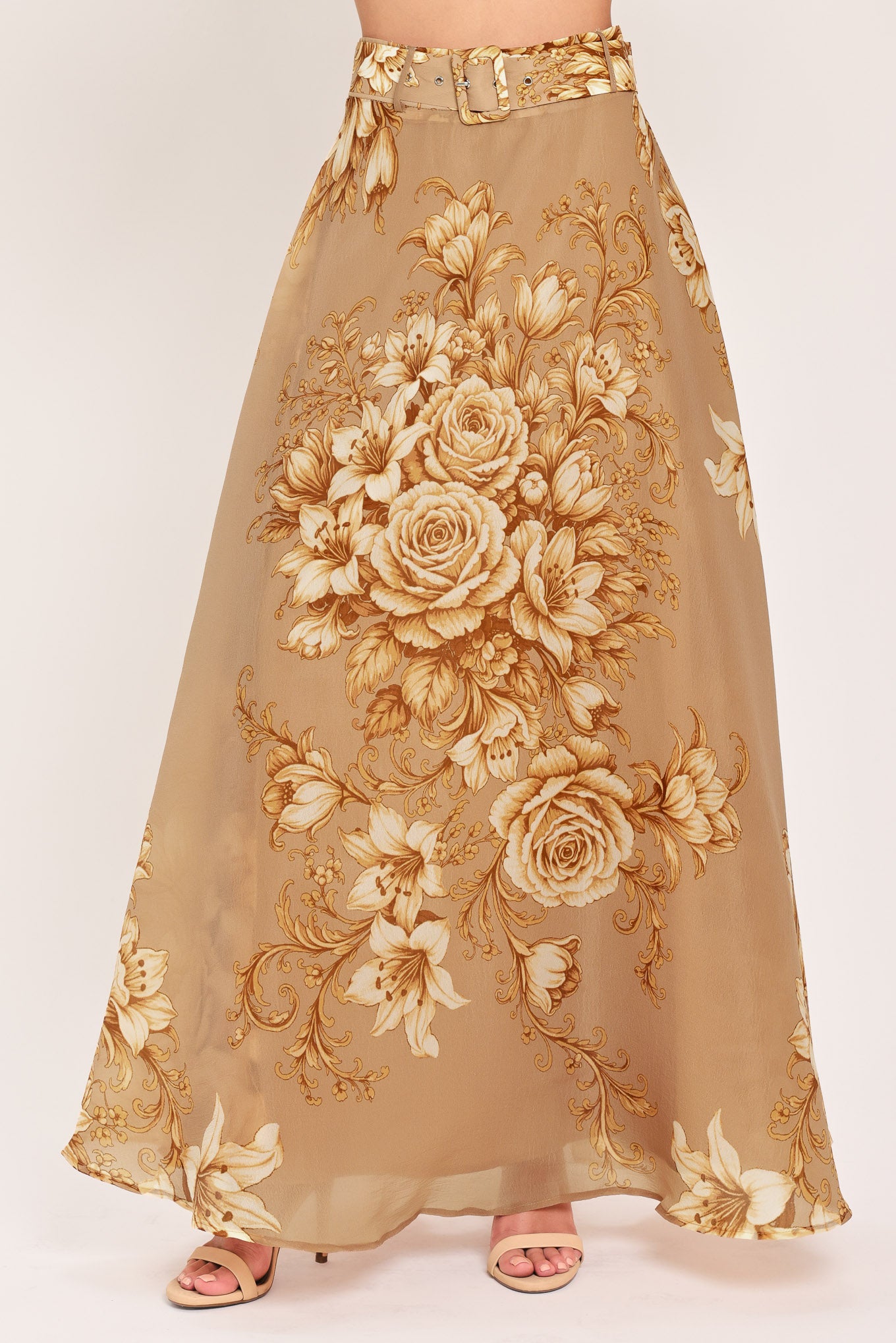 A floor-length beige skirt with a large gold and cream floral rose pattern, featuring a matching beaded belt, shown on a model | Flying Tomato