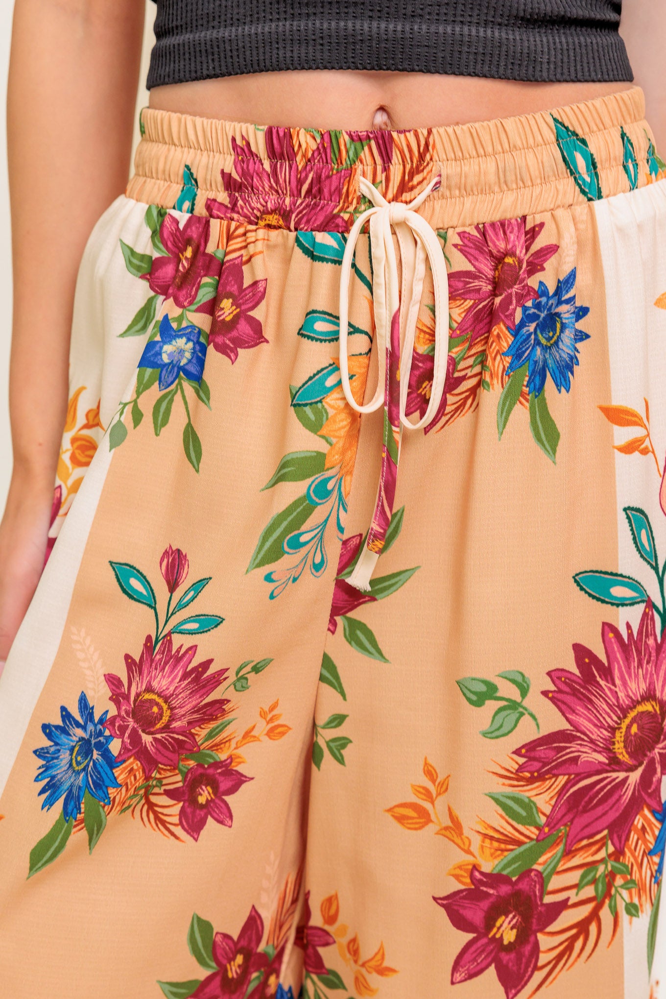 A printed woven pant with elasticized waist and tie