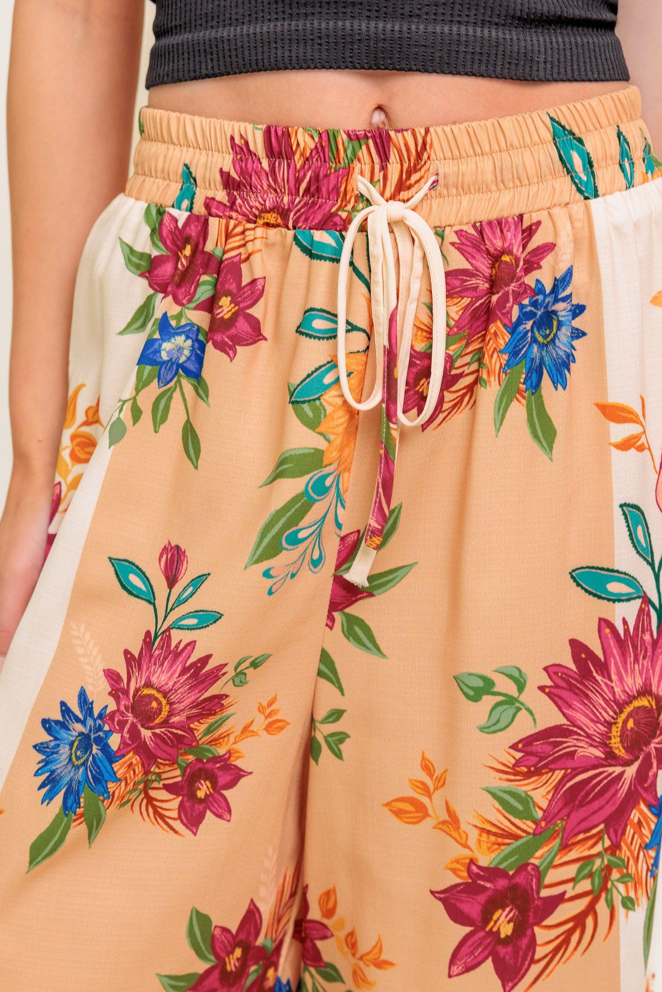 A printed woven pant with elasticized waist and tie