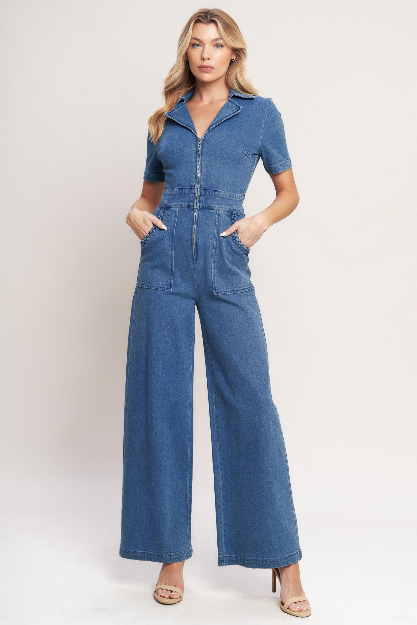 A washed denim jumpsuit featuring collar, front zipper closure, short sleeve, side pockets with braided trim and wide leg
Details:
Self : 85% Cotton 12% Polyester 3% Spandex
Size & Fit
- Model is 5`8" And Wearing Size Small
- Measurements Taken From Size Small
- Approx. Length: 60"