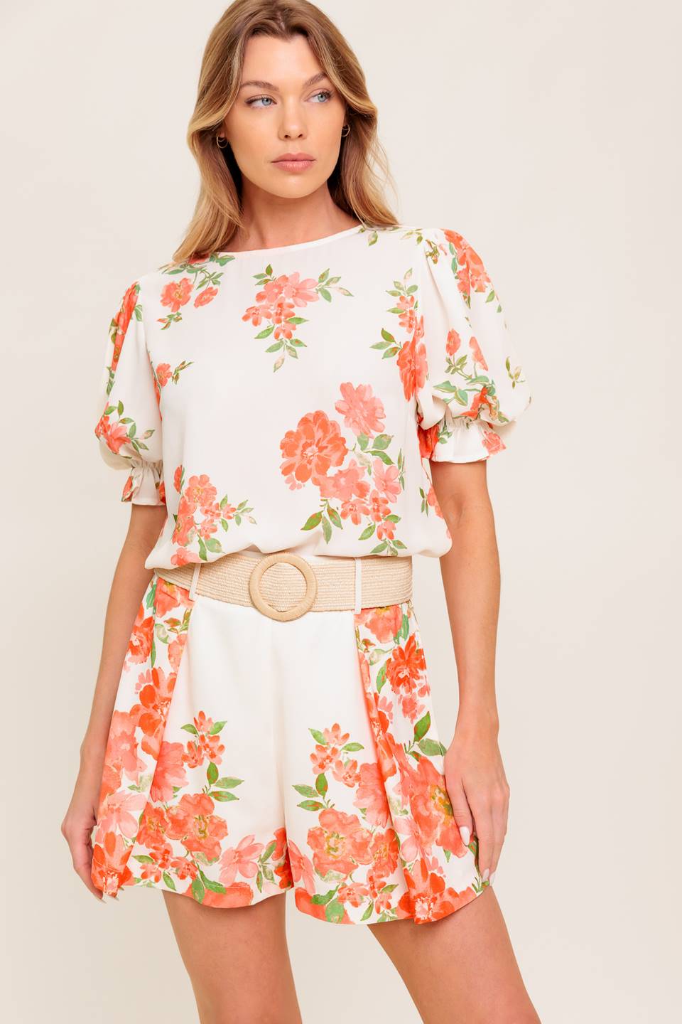 A printed woven short featuring belt and side zipper closure.