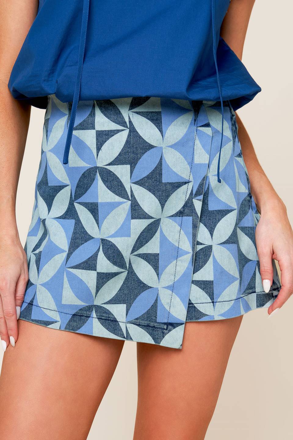 A printed denim skort with side zipper closure