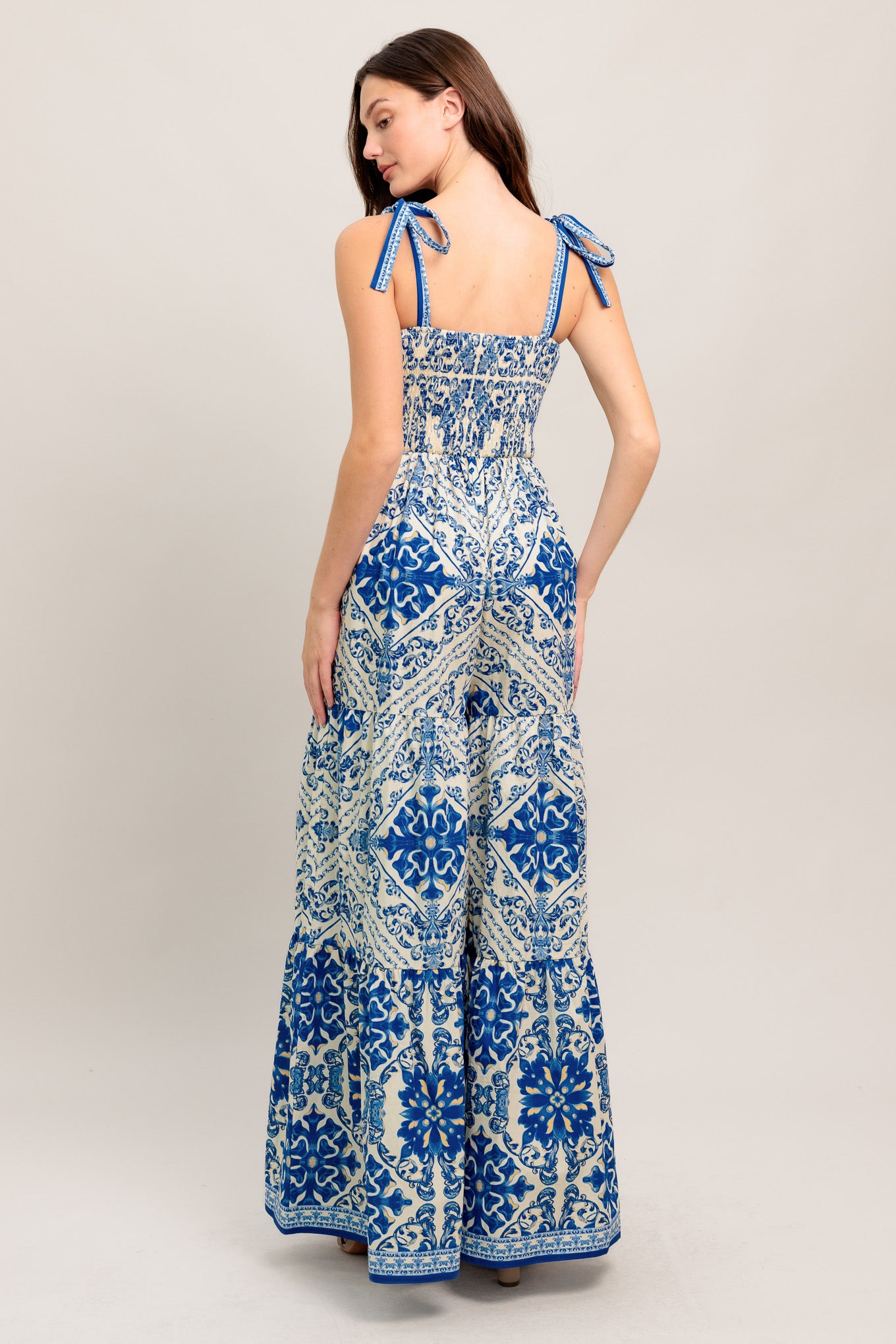 A printed woven jumpsuit featuring sweetheart neckline, shoulder tie, tiered pant and smocked back bodice
Details:
Self : 100% Cotton
Size & Fit
- Model is 5`8" And Wearing Size Small
- Measurements Taken From Size Small
- Approx. Length: 58"