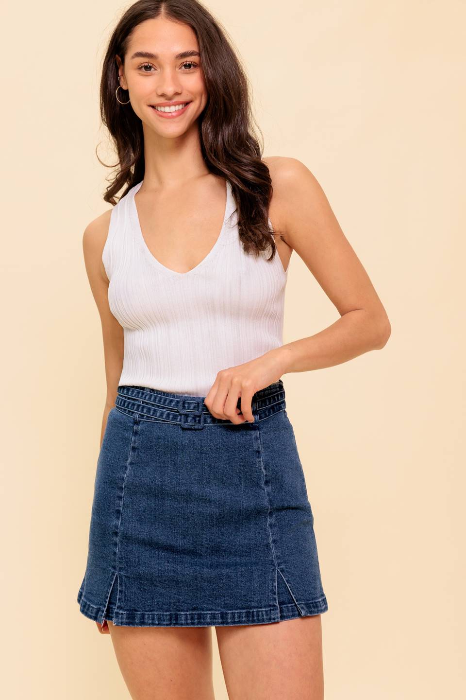 A washed denim skort featuring two front slit, double self belt, back pockets and side zipper closure