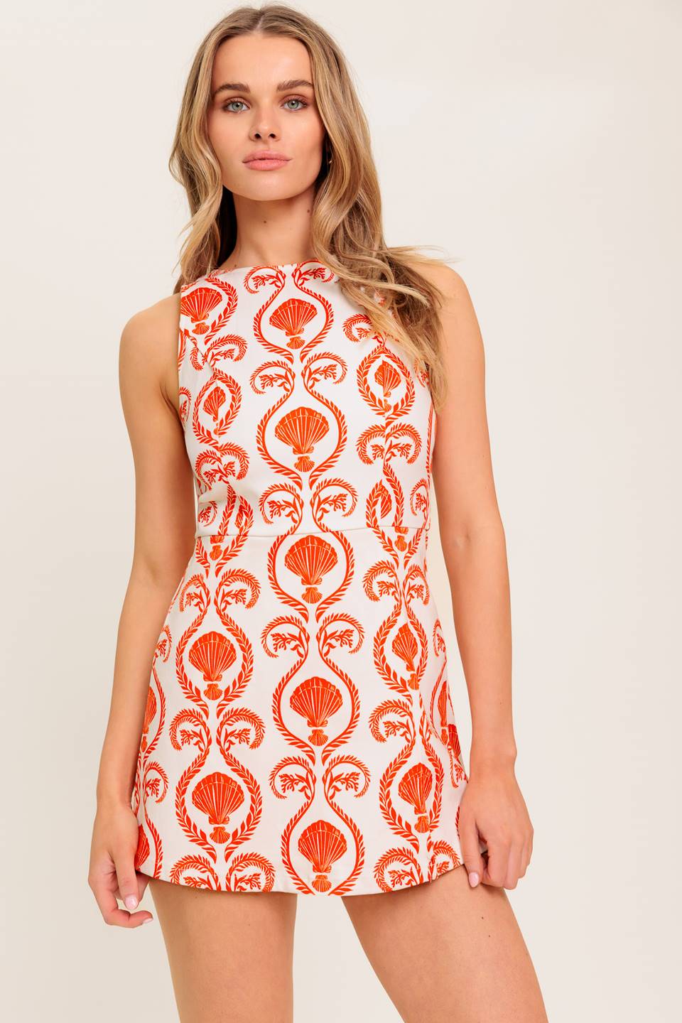 A printed woven skort romper featuring round neckline, sleeveless and back zipper closure.