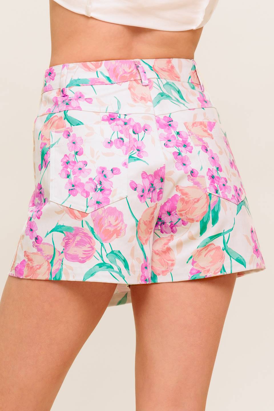 A printed woven skort featuring front closure and side pockets.