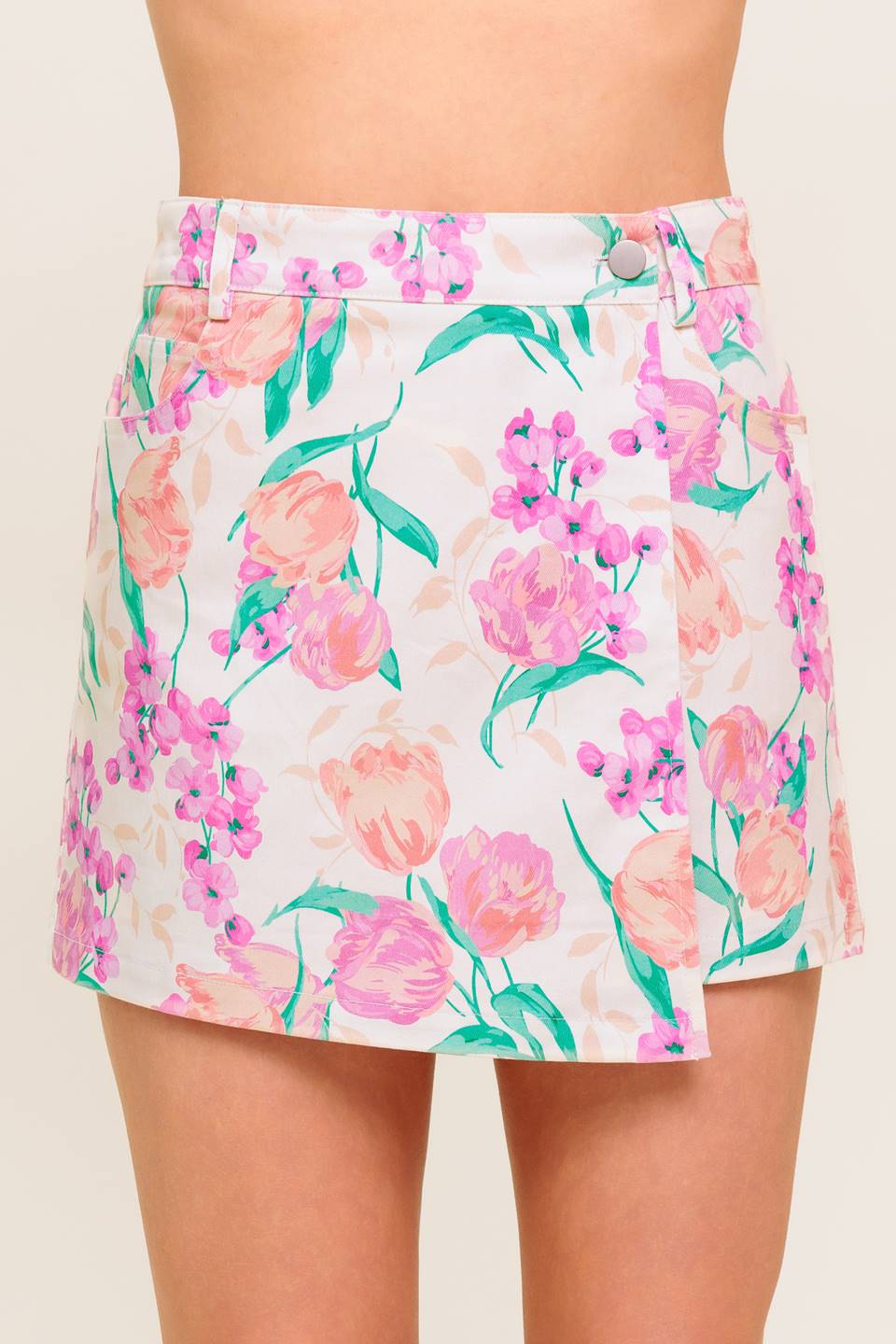 A printed woven skort featuring front closure and side pockets.