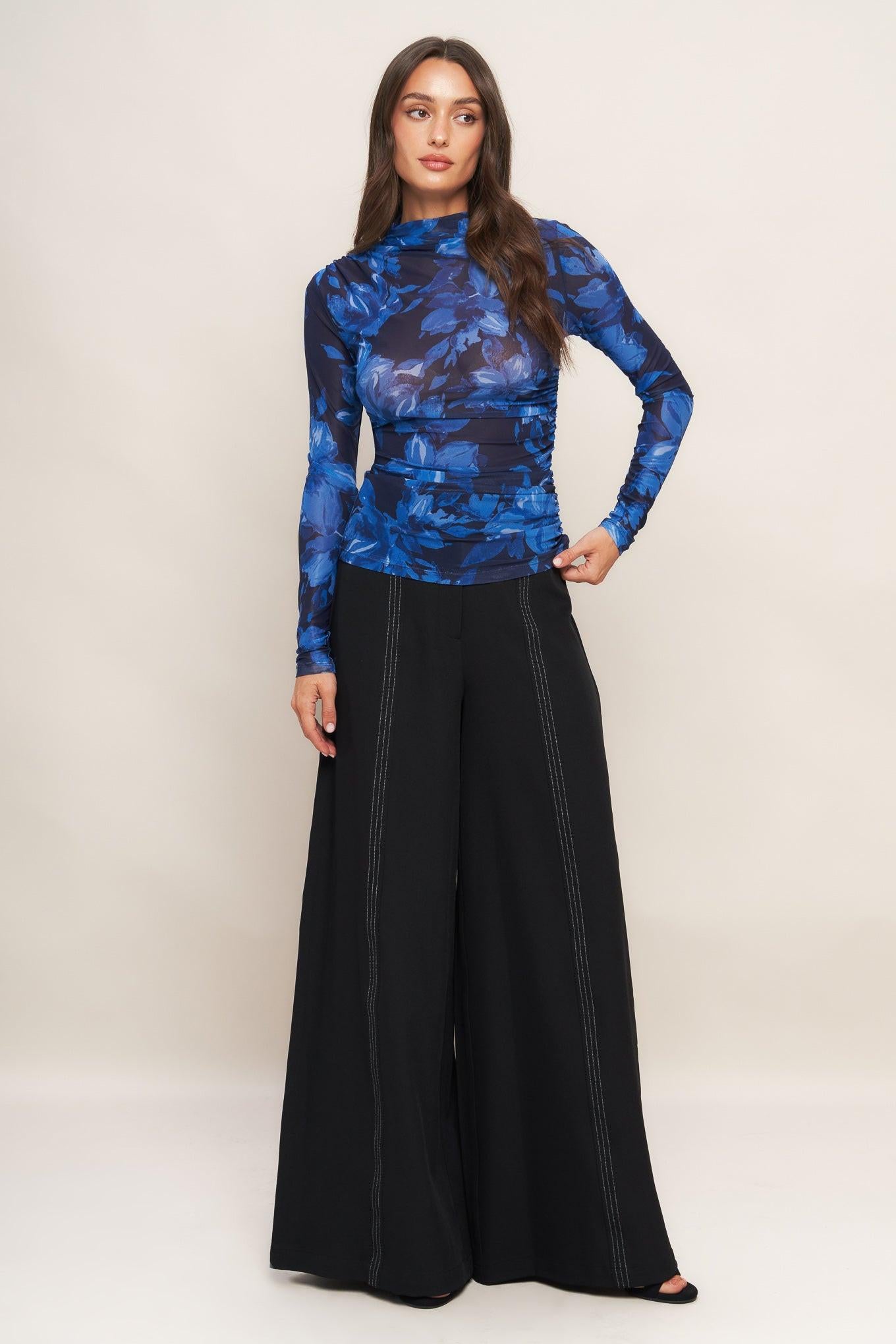 A solid woven wide leg pant with side zipper closure