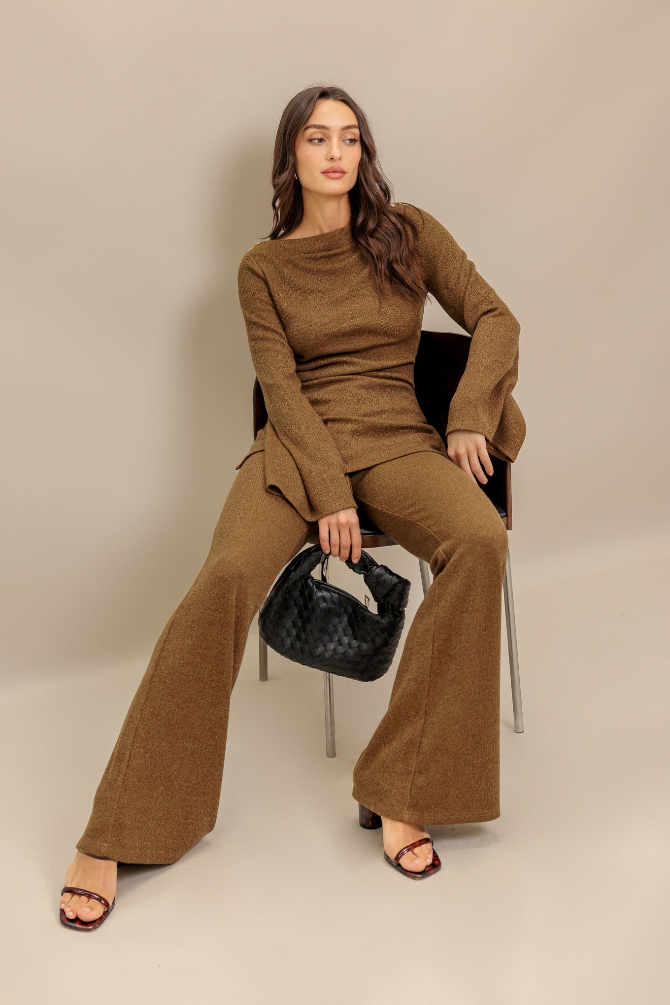 A solid knit pant featuring elasticized waist, flare leg and tassel tie. Matching top IT13842