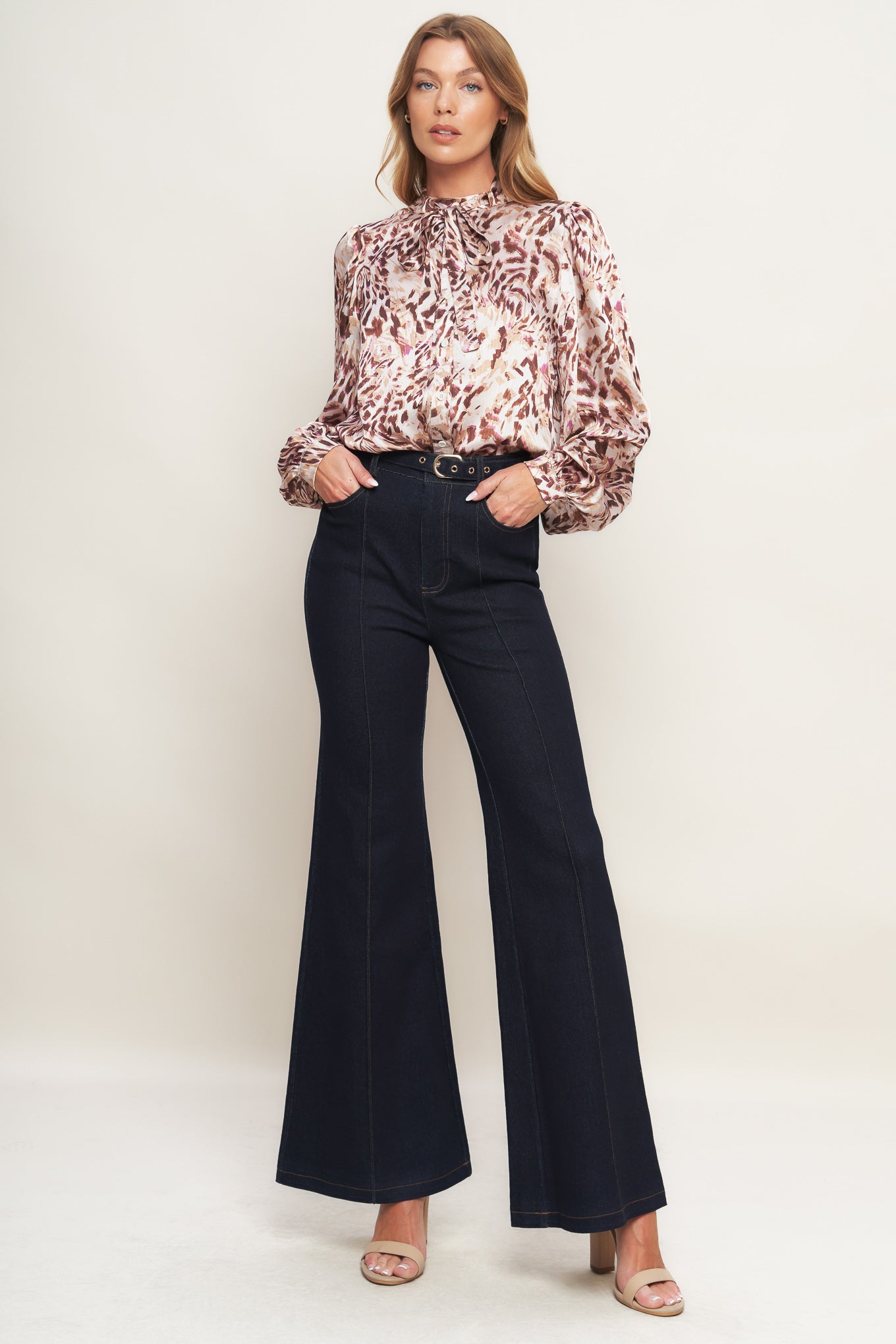 A denim pant featuring front closure, side pockets, self belt and flare leg