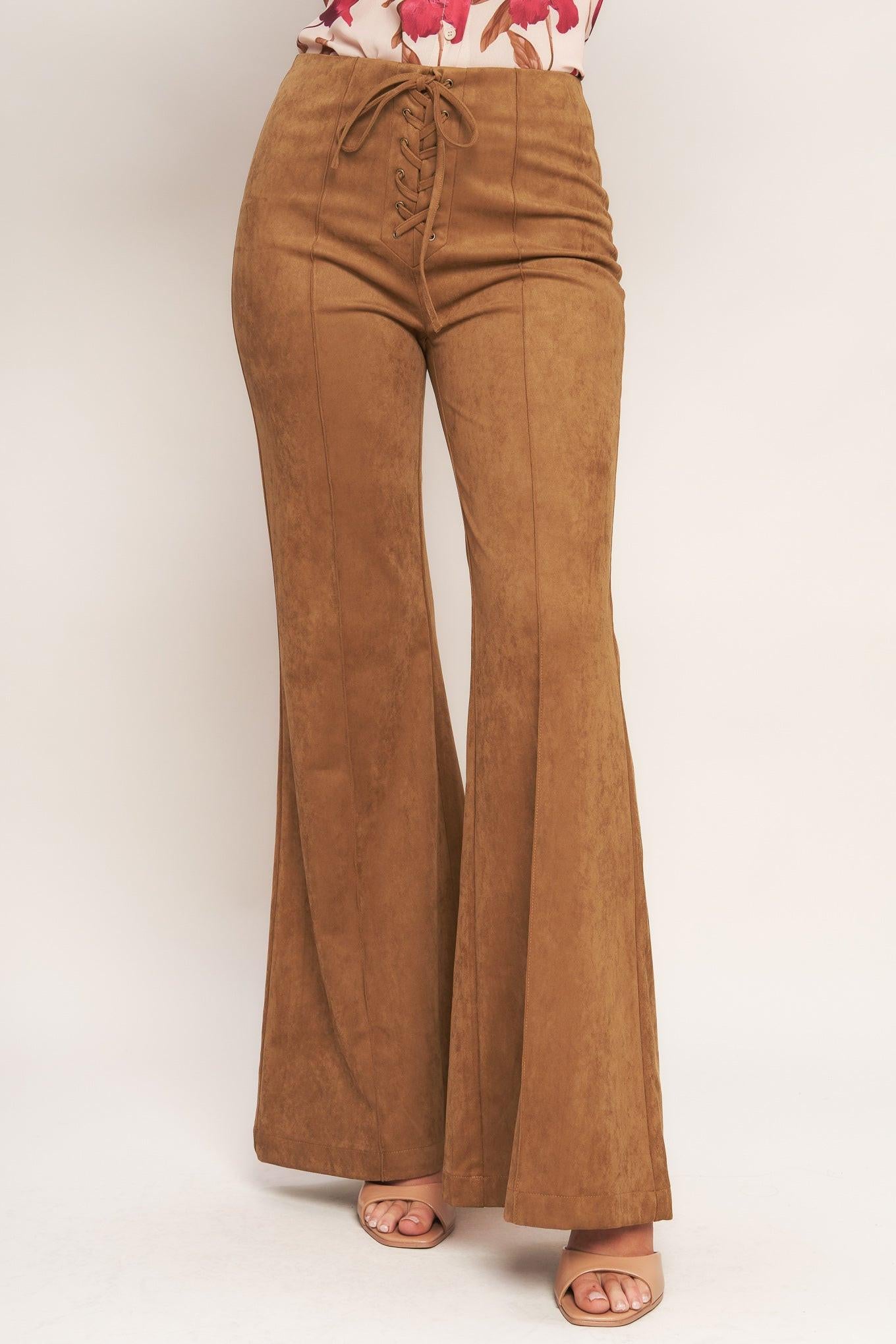 A faux suede pant featuring front lace up detail, flare leg and back zipper closure