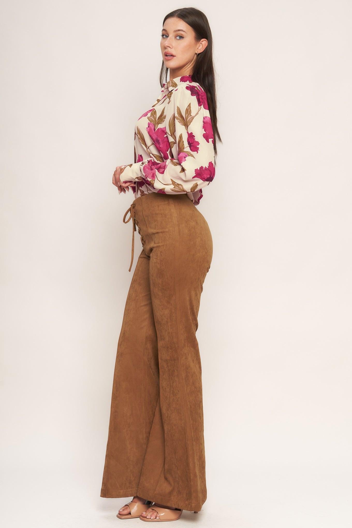 A faux suede pant featuring front lace up detail, flare leg and back zipper closure