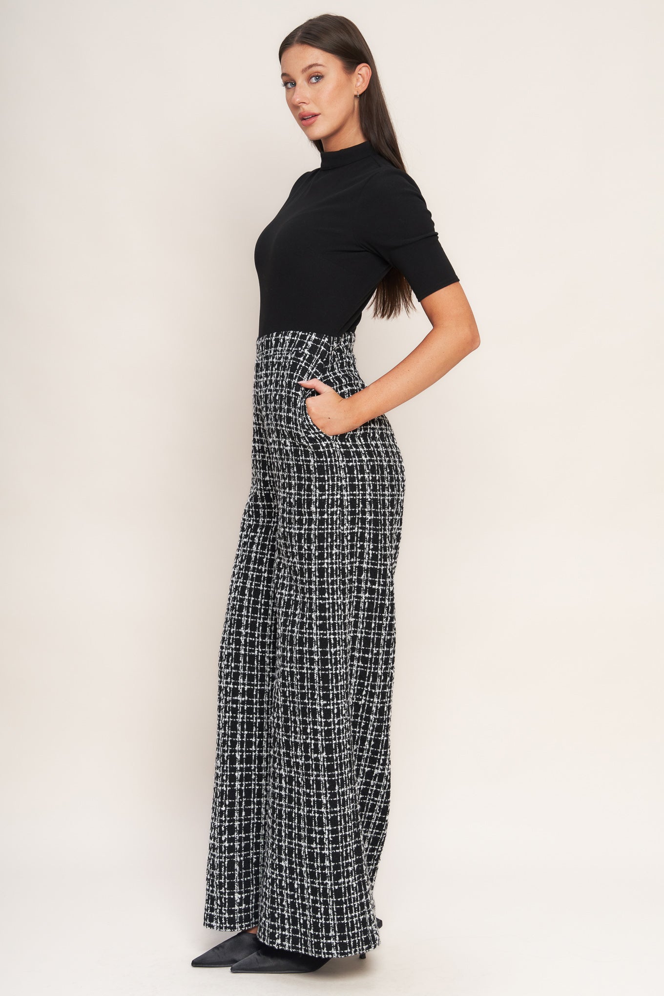 A ribbed knit top and tweed pant jumpsuit featuring mock neckline, short sleeve, side leg and back zipper closure