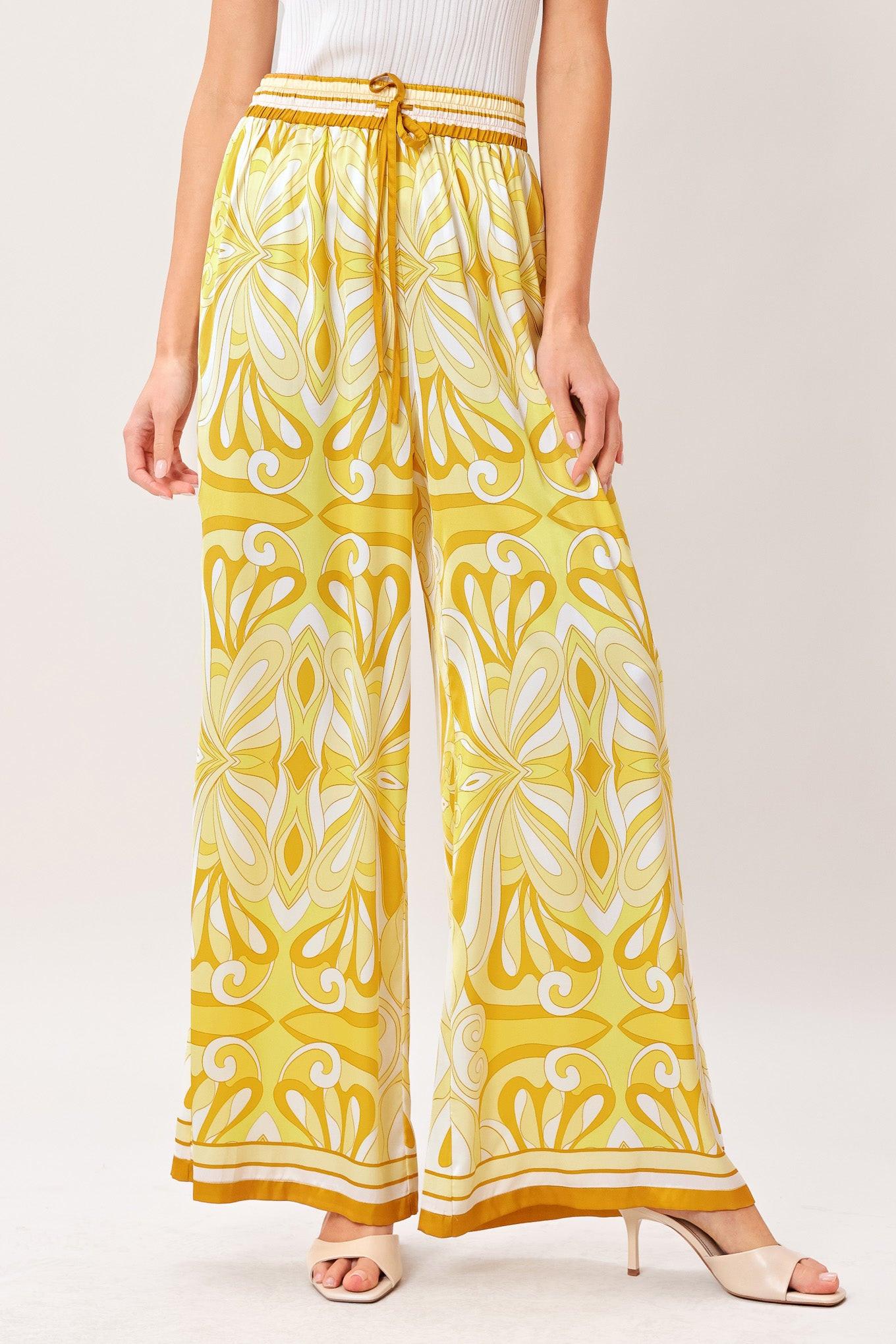 A printed woven pant with elastic waist with tie and wide leg