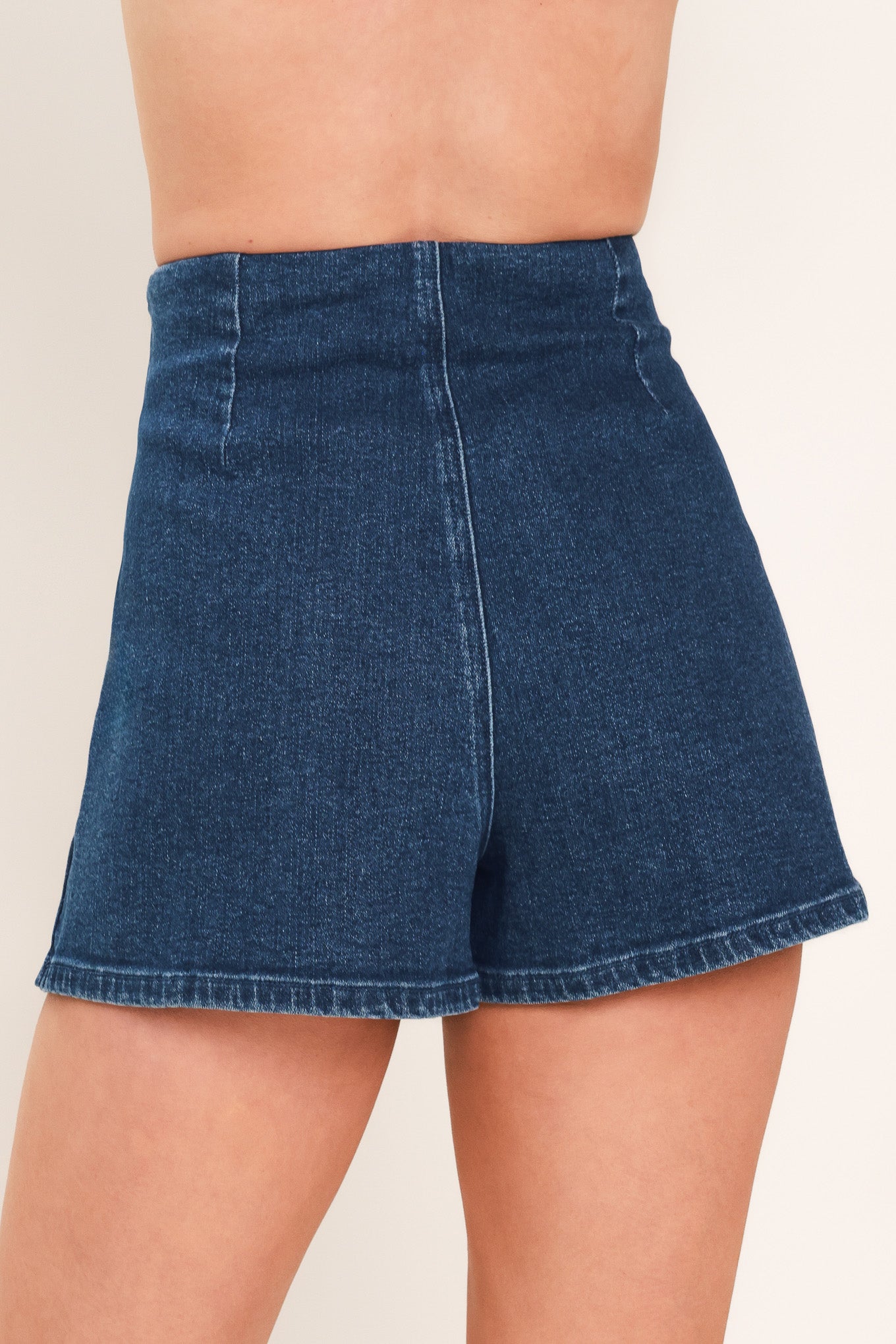 A woman wearing a dark blue denim mini skort | Flying Tomato