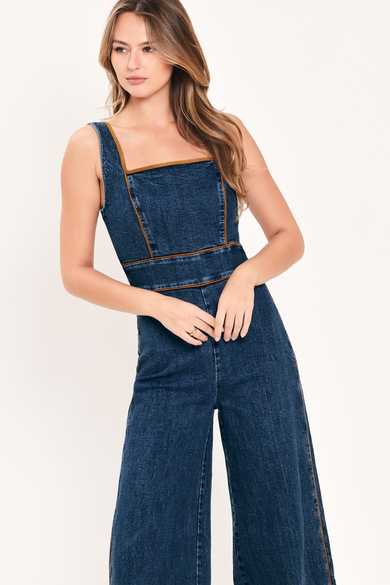 A woman modeling a dark blue denim wide-leg jumpsuit with square neckline | Flying Tomato