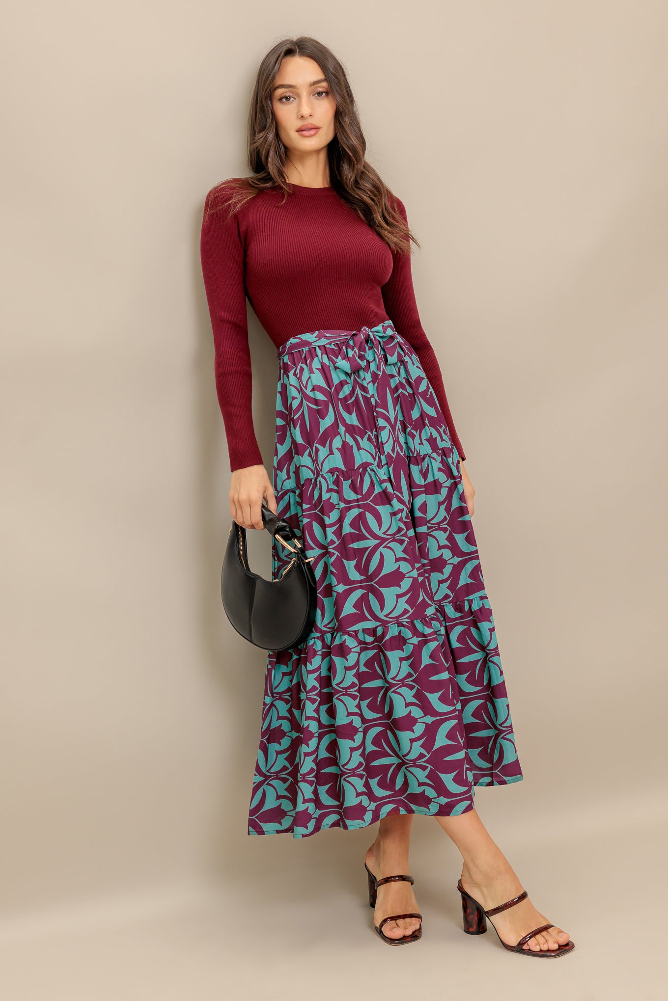 A sweater knit top and printed woven midi dress featuring round neckline, long sleeve and tiered skirt with sash tie