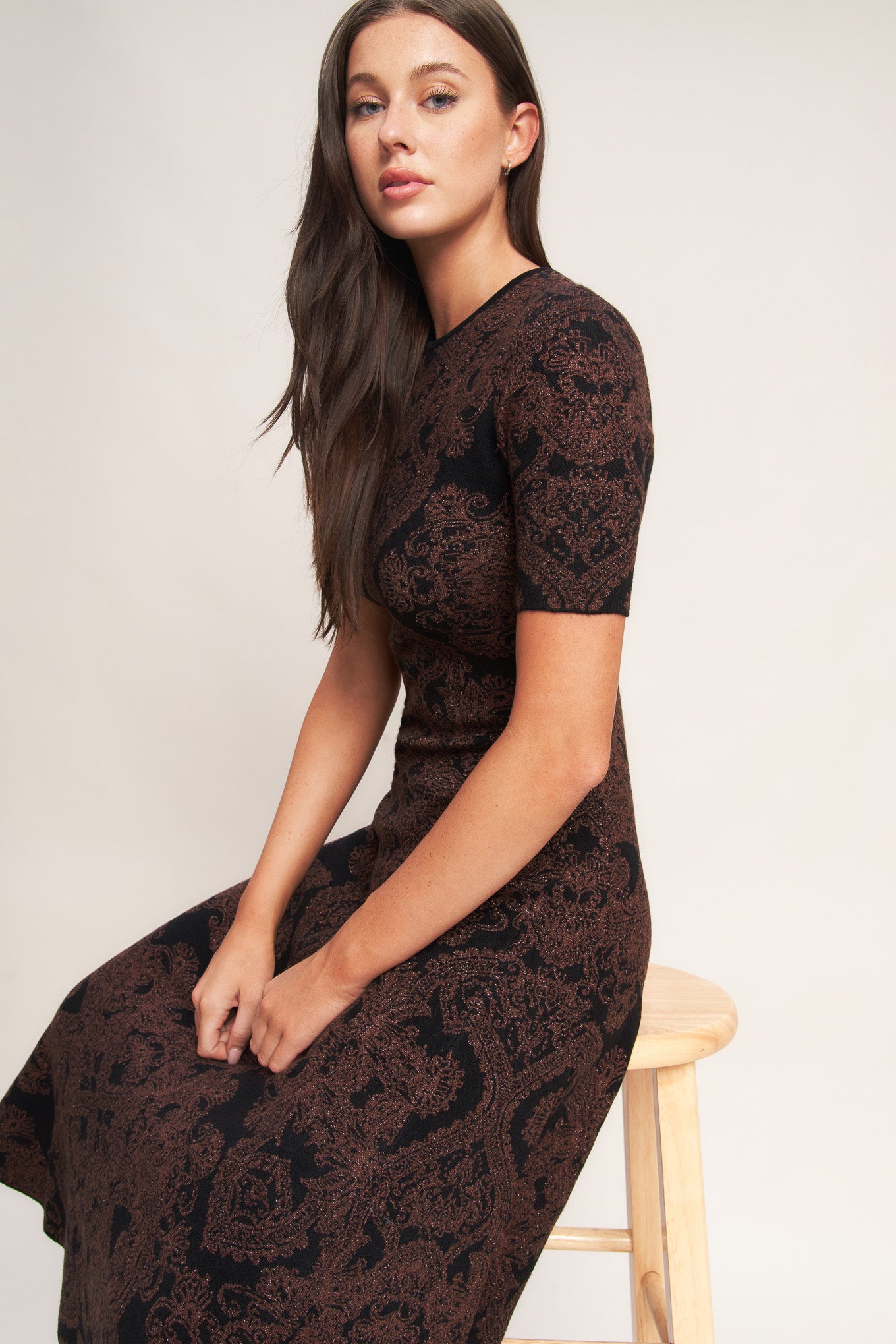 A jacquard sweater midi dress featuring crew neckline, short sleeve, circle skirt and back neck zipper closure