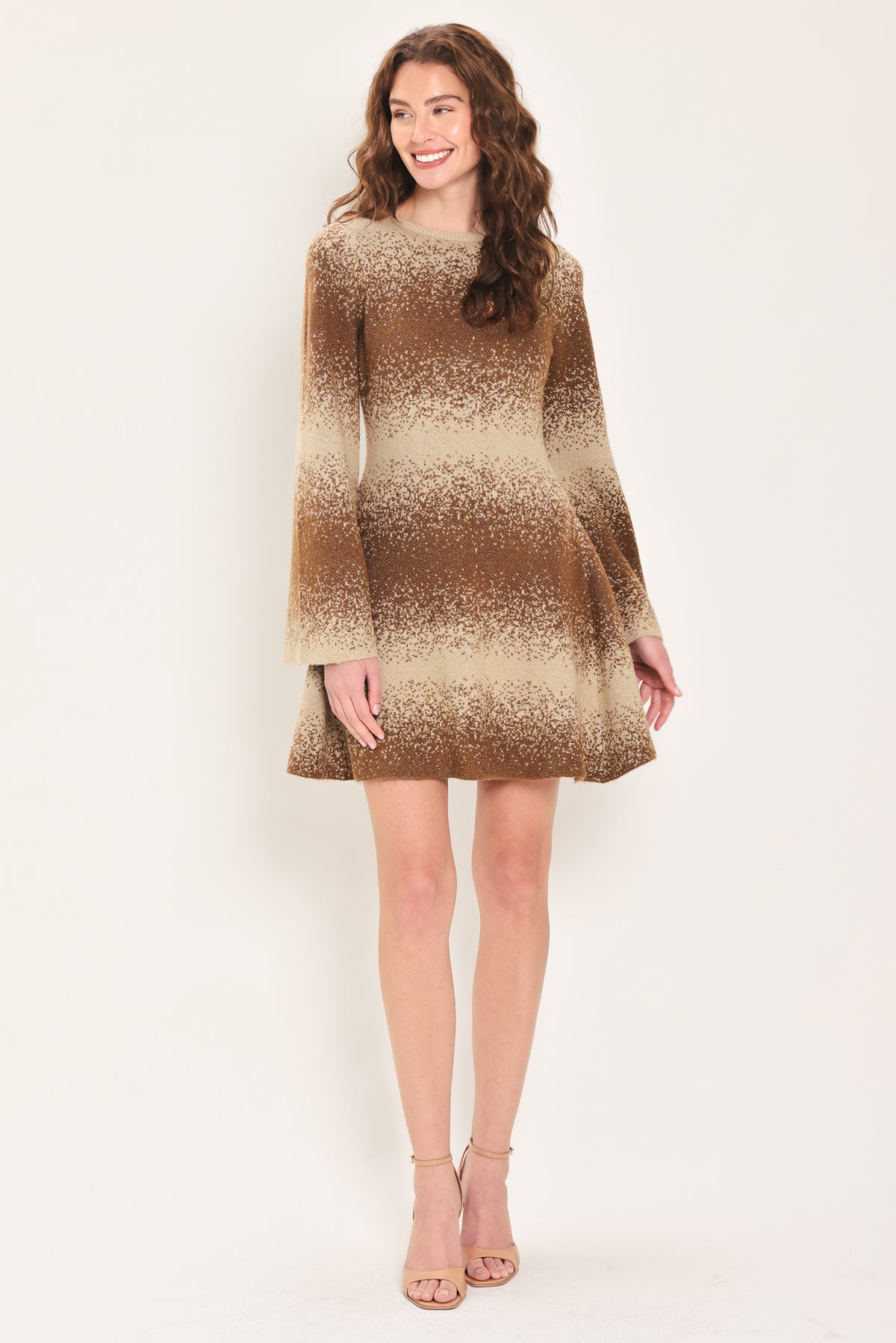 Woman wearing a brown and beige sweater knit flared mini dress with long sleeves | Flying Tomato