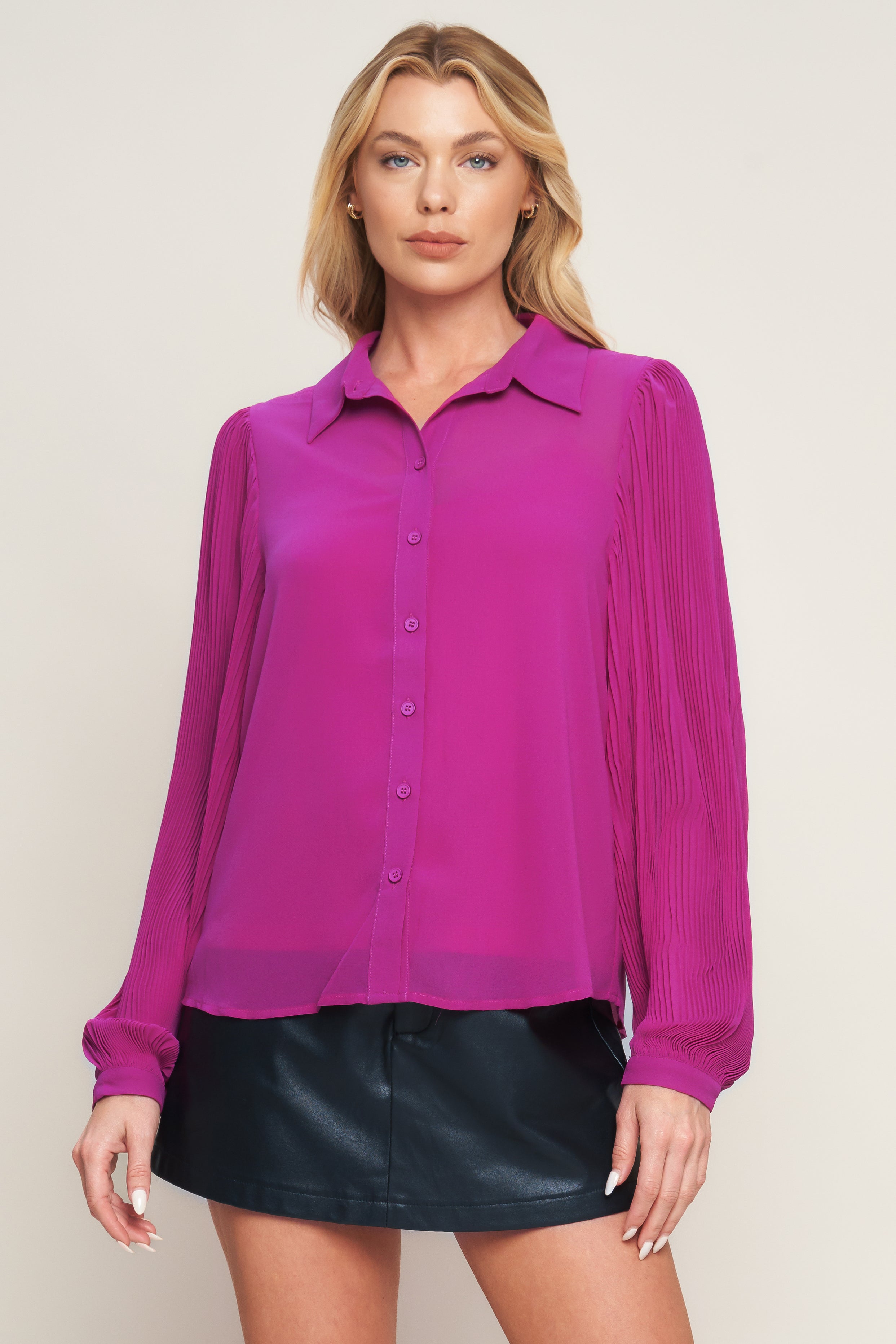 A solid woven top featuring shirt collar, button down, long baby pleated sleeve with cuff