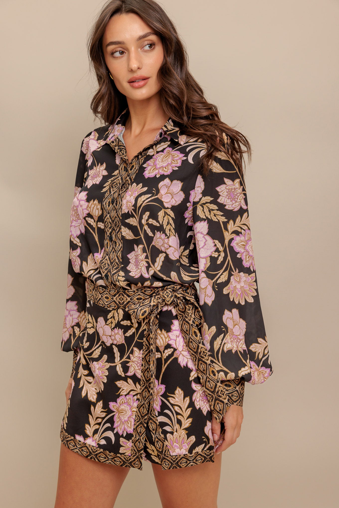 A printed woven top with front button down and long sleeve
