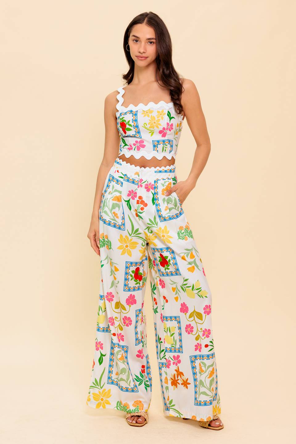A printed woven top and pant set. Crop top with ric rac strap and trim with smocked back bodice. Pant featuring ric rac trim, front closure, side pocket and wide leg