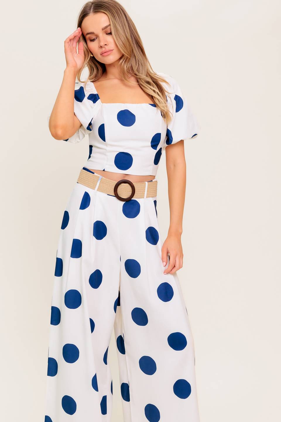 A printed top and pant set. Top featuring square neckline, short puff sleeve and smocked back bodice. Pant featuring side leg with side zipper closure.