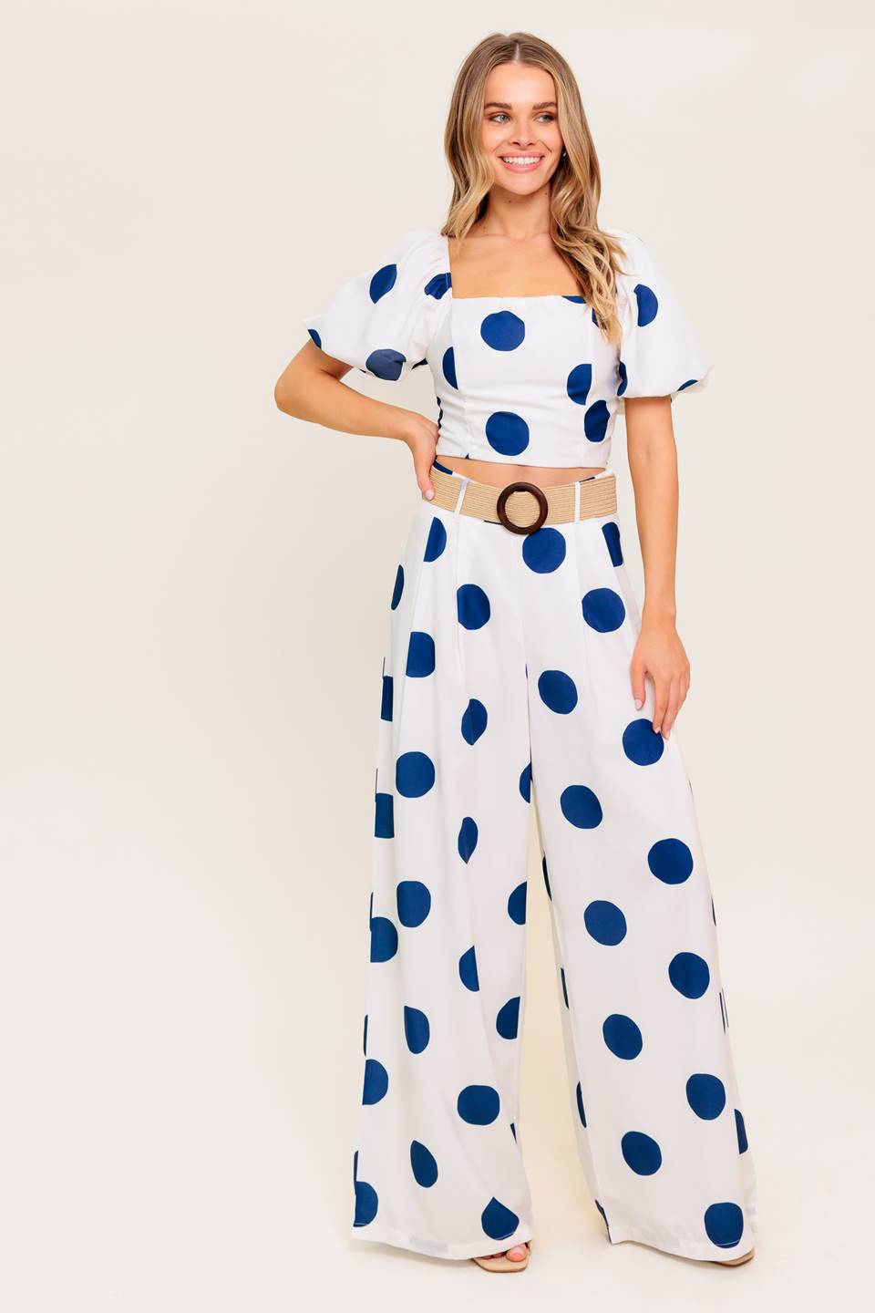 A printed top and pant set. Top featuring square neckline, short puff sleeve and smocked back bodice. Pant featuring side leg with side zipper closure.