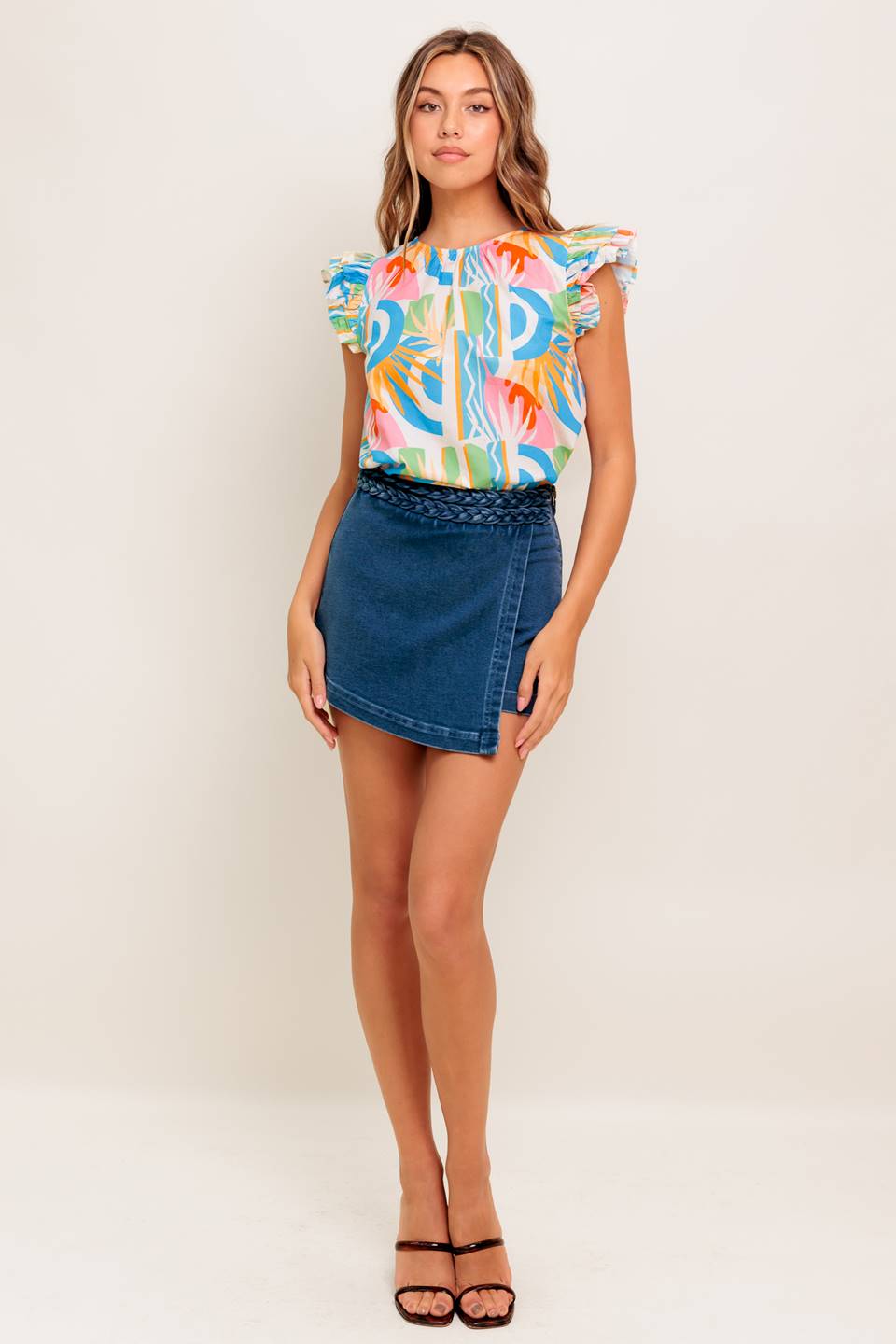 A printed woven top featuring round neckline, double ruffled sleeve and back keyhole button closure