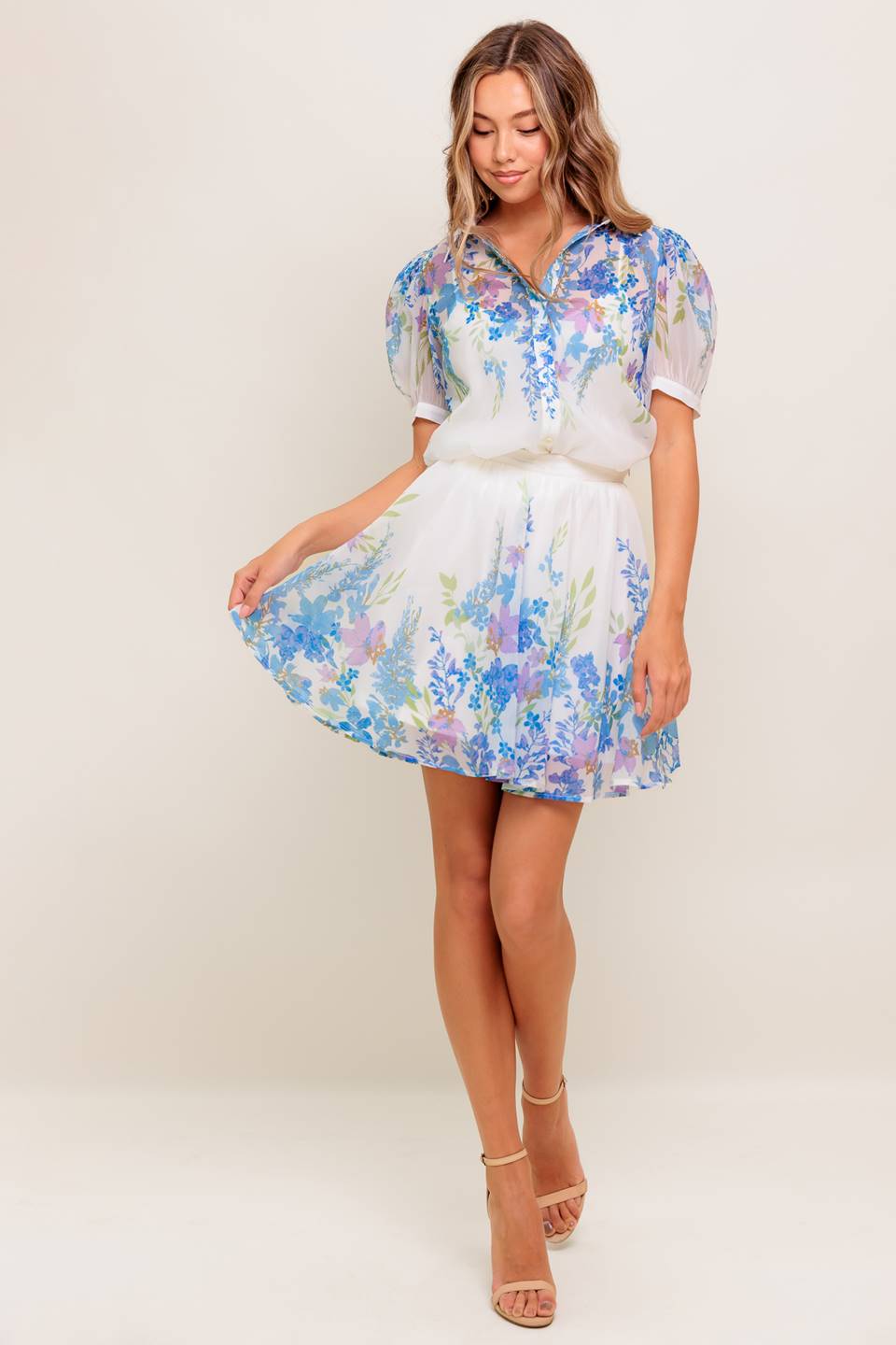 A printed woven top featuring collar, short sleeve, button down and cami.