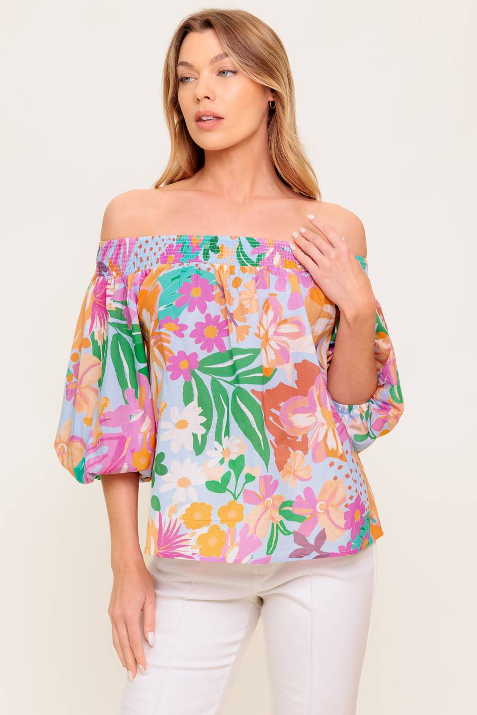 A printed woven top with off shoulder neckline.