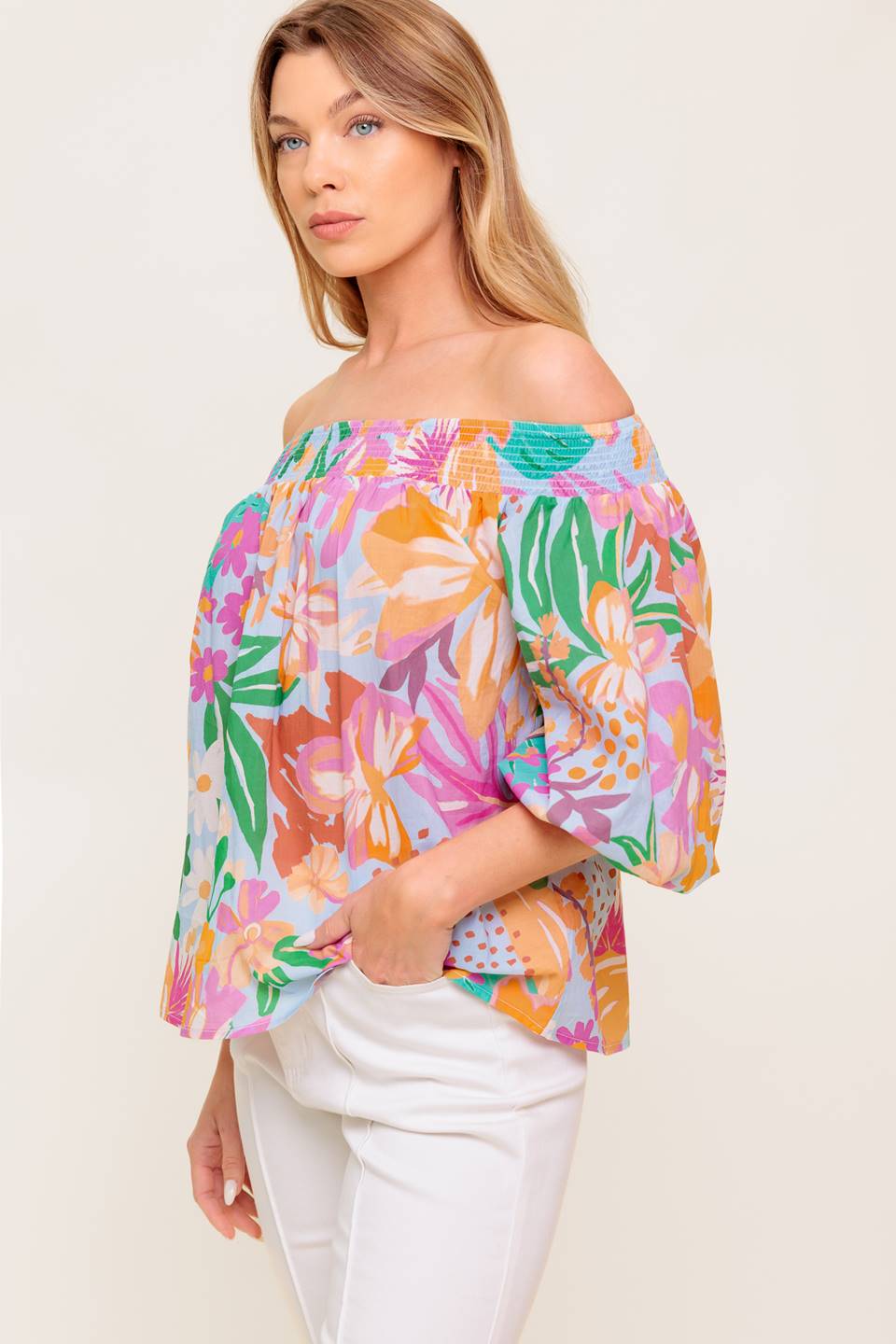 A printed woven top with off shoulder neckline.