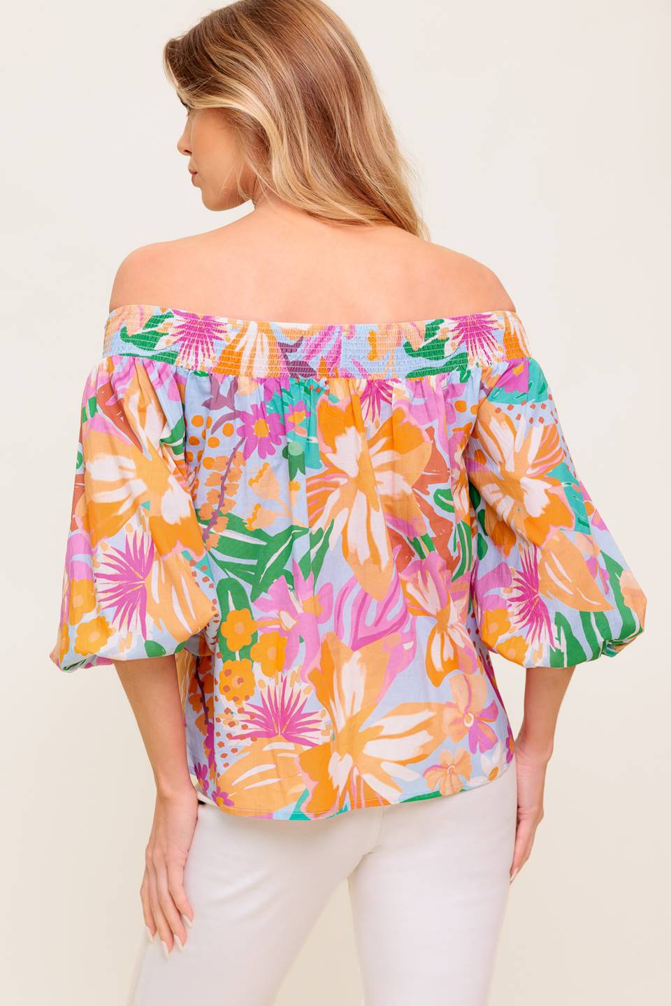 A printed woven top with off shoulder neckline.