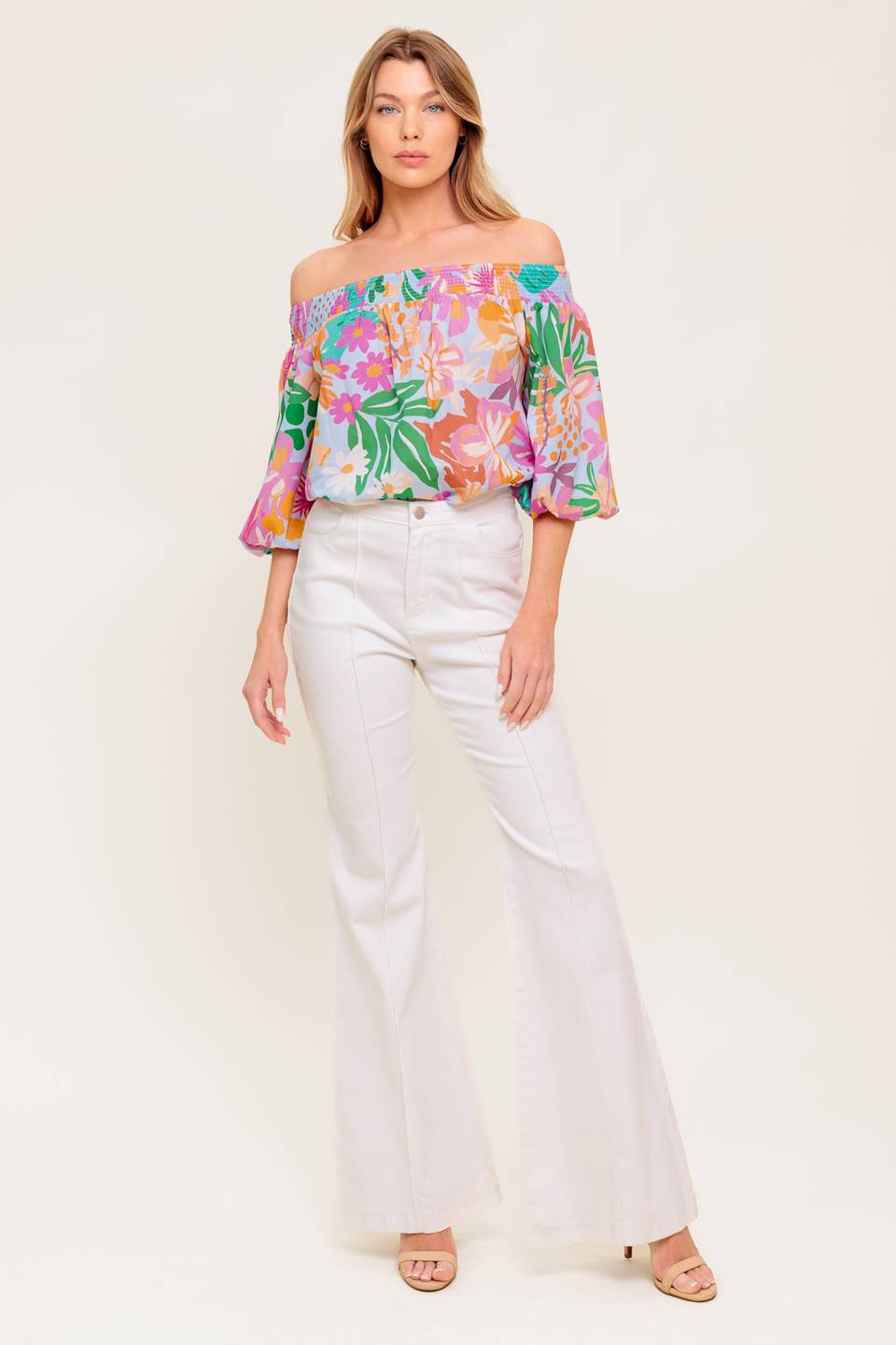 A printed woven top with off shoulder neckline.