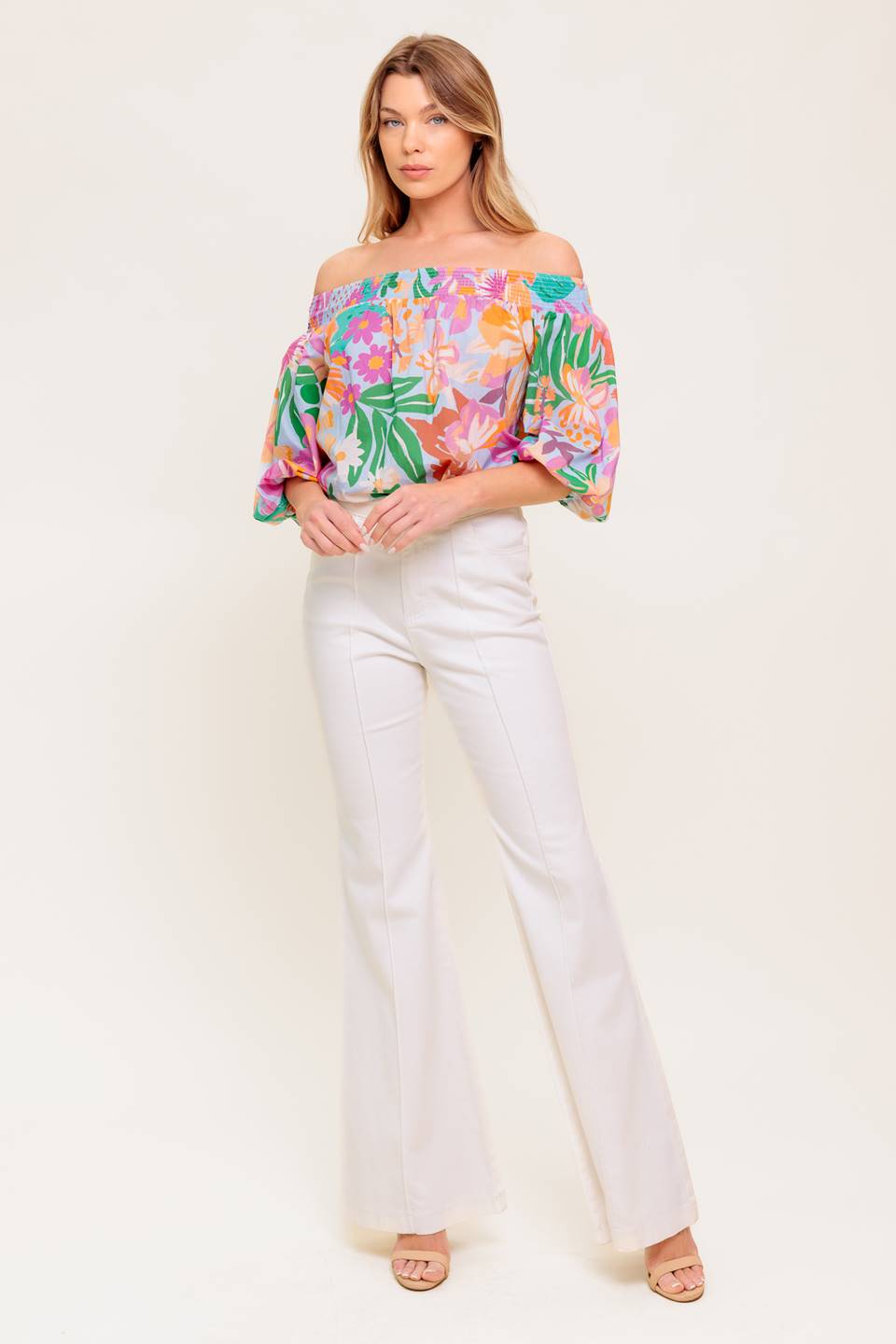 A printed woven top with off shoulder neckline.