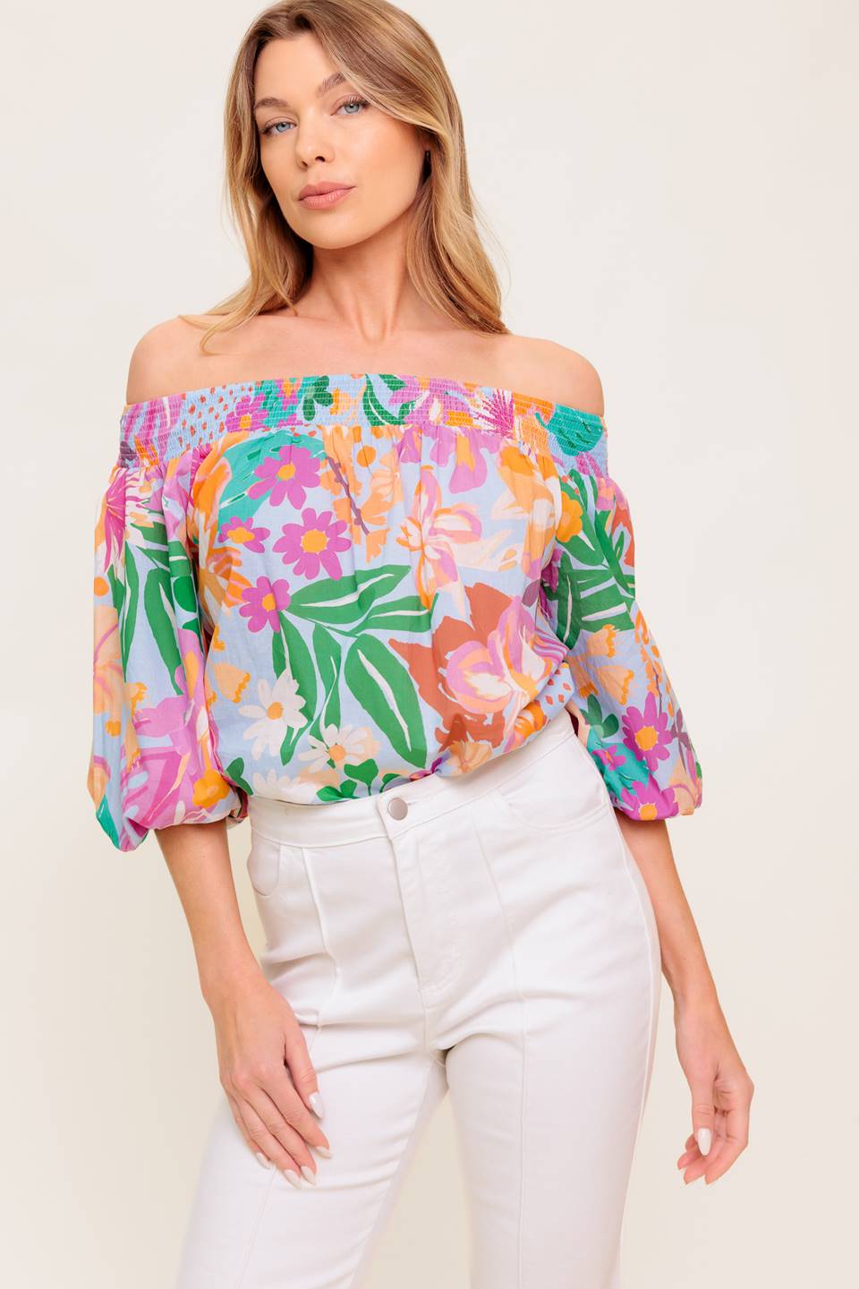 A printed woven top with off shoulder neckline.