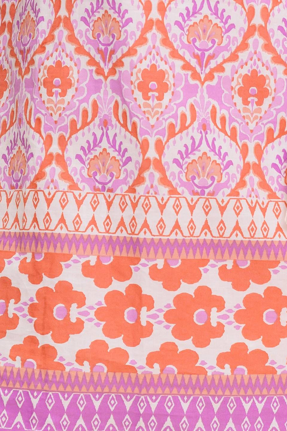 A printed woven top featuring wide neckline with ruffled edge, short sleeve and contrasting tie