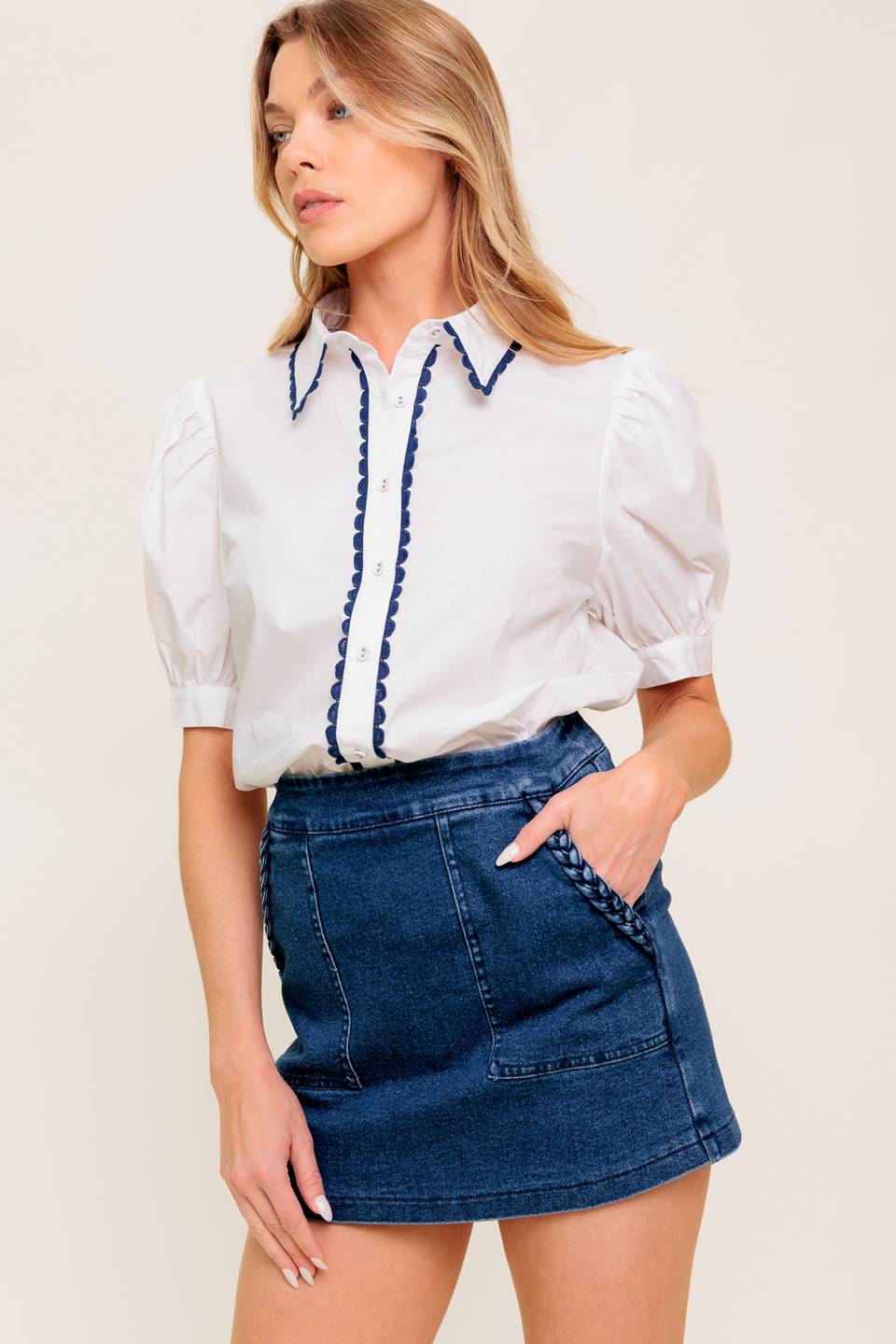 A solid woven top featuring collar, button down, short puff sleeve and laced edge.