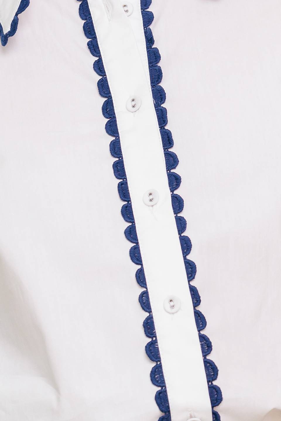 A solid woven top featuring collar, button down, short puff sleeve and laced edge.